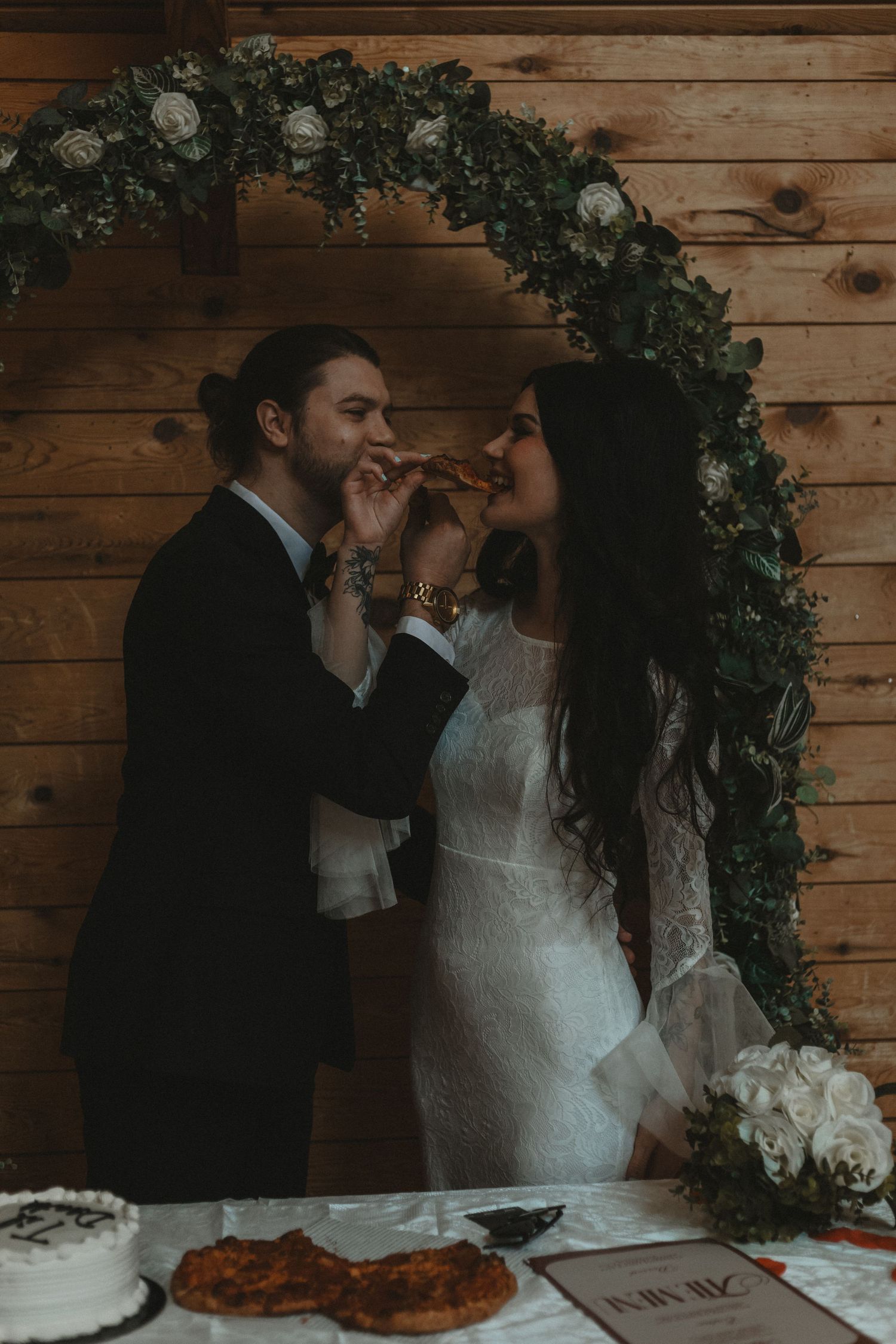 Local Sudbury Wedding Photographer captures bride and groom on wedding day in Sudbury ontario eating pizza