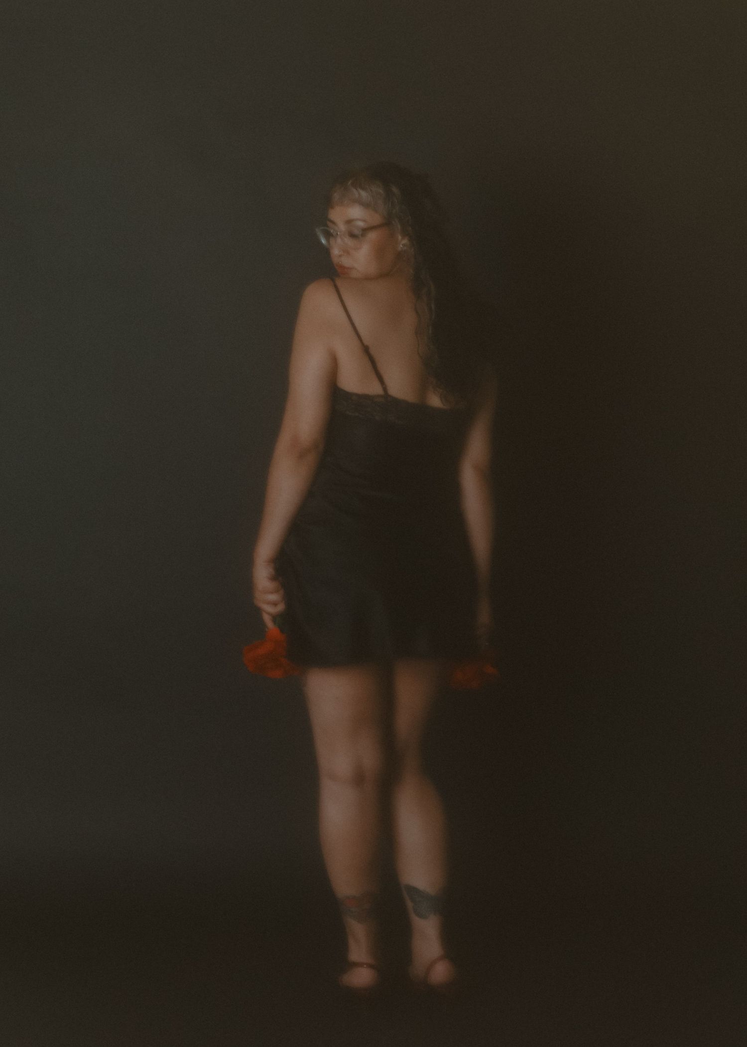 local Sudbury Boudoir expert photographer provides burlesque boudoir experience to model in black dress