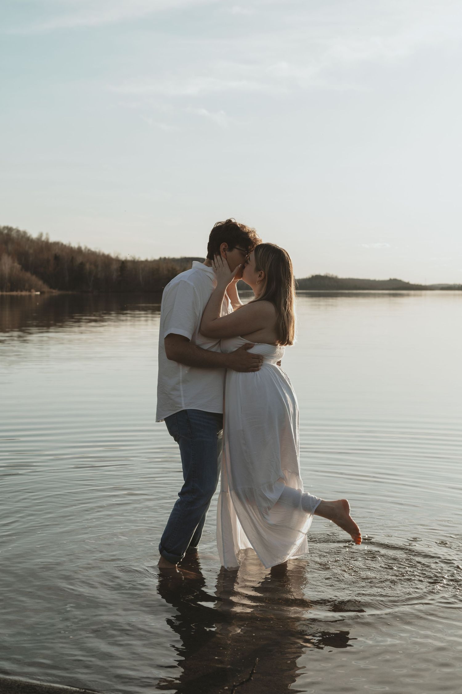 Sudbury engagement photographer specializing in natural light photography of couple kissing at the beach