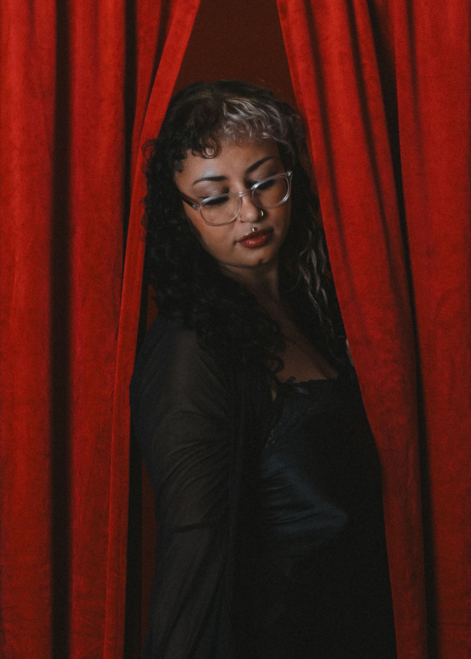 local Sudbury Ontario Boudoir expert photographer provides burlesque boudoir experience to model in black dress