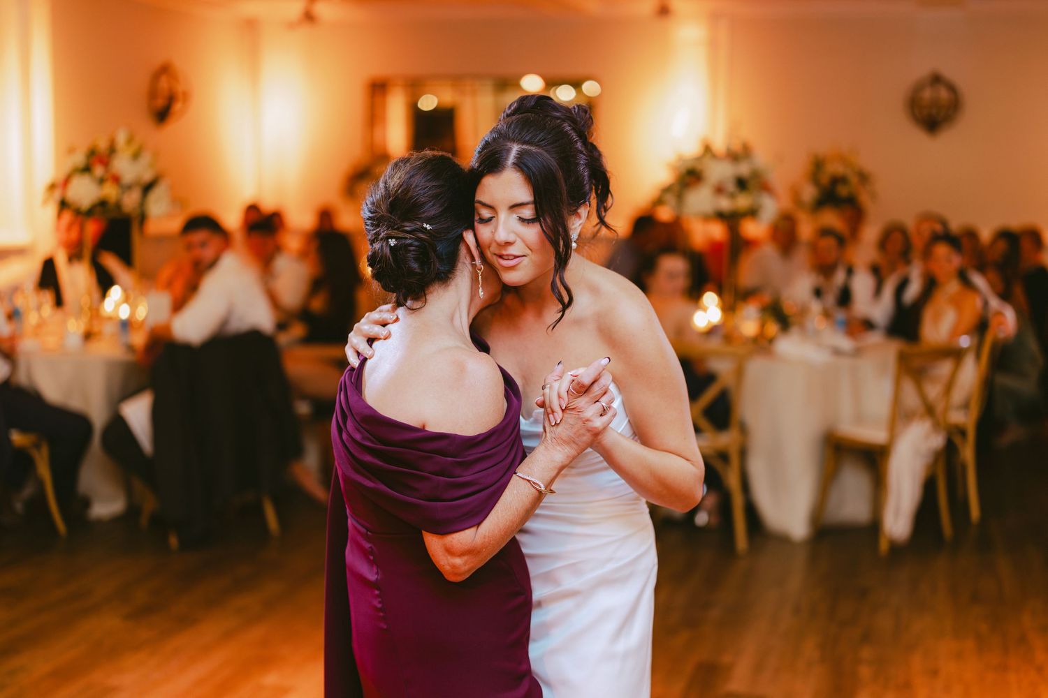 Bride shares an emotional dance with her mother at the wedding reception.
