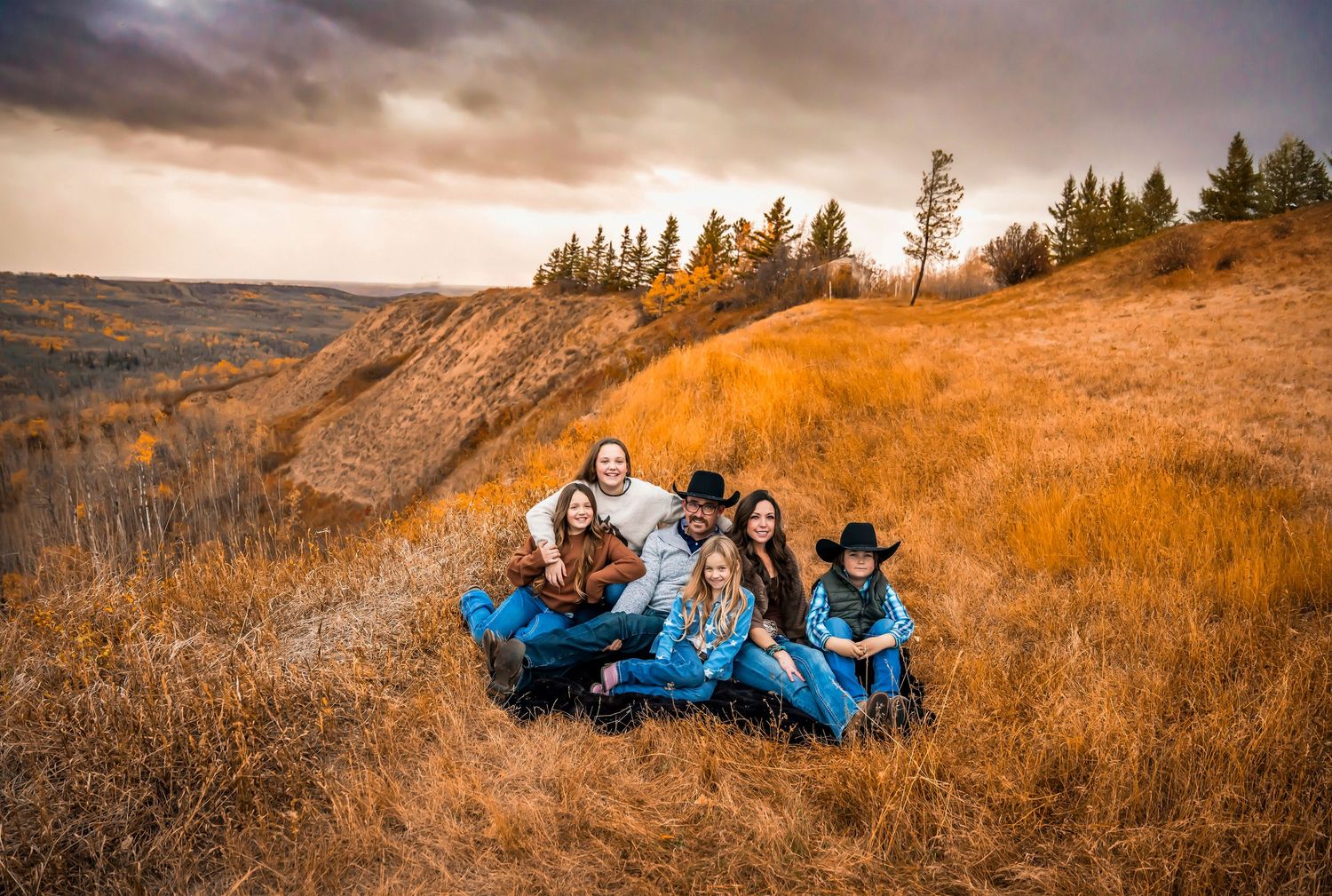 family on hills edge