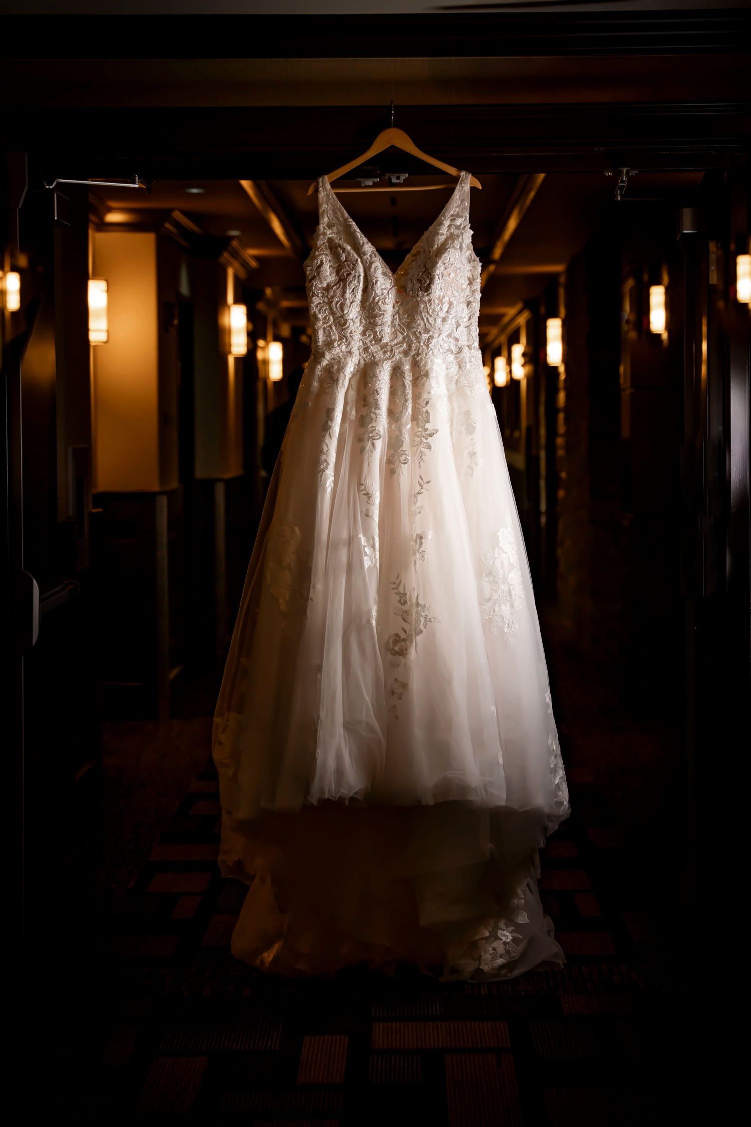 wedding dress hanging in hall