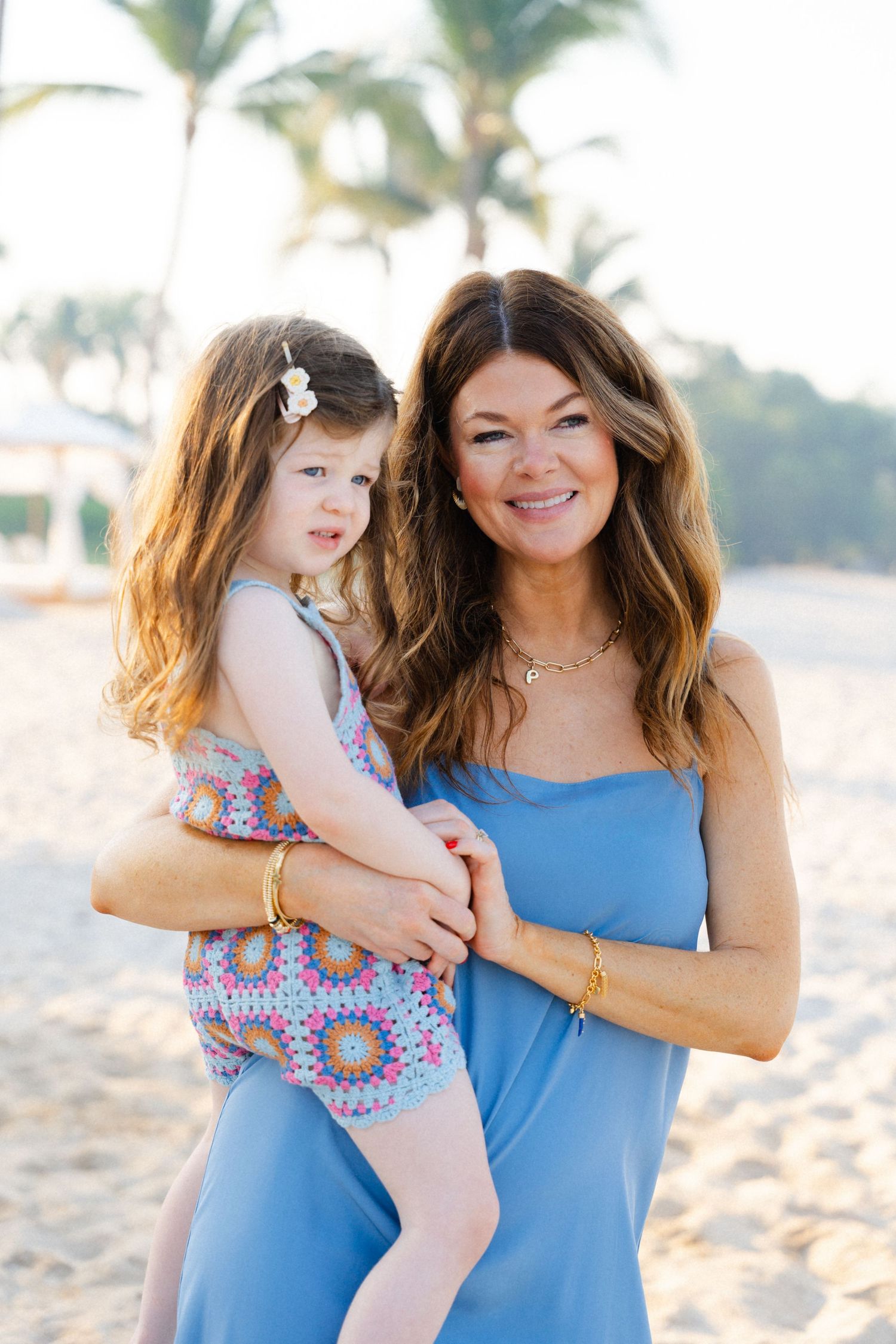Mom holding her daughter on the beach at Susurros del Corazon Punta Mita Mexico — Marina Pochepkina Photography