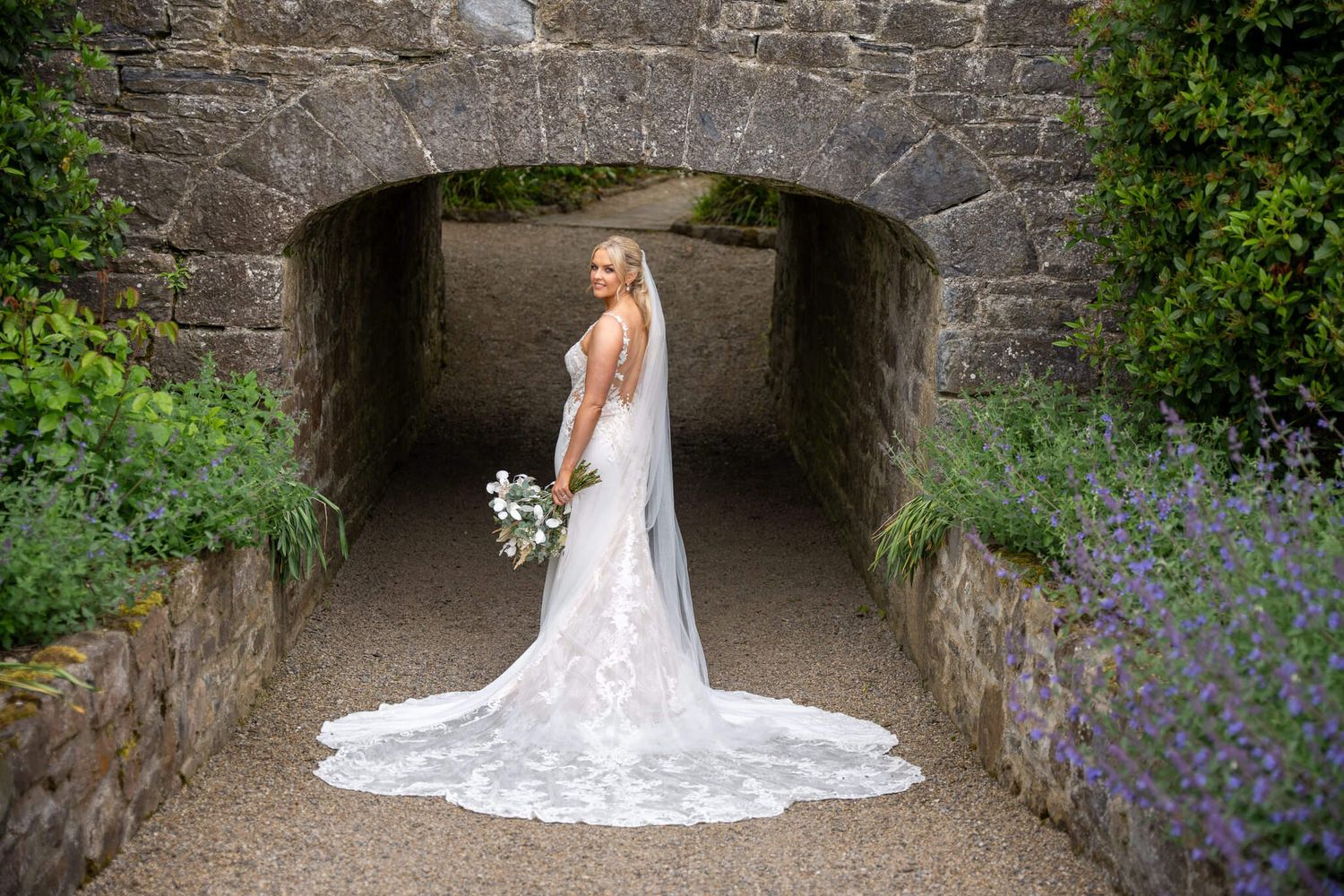 Bride in a long lace wedding gown at historic and stunning Clonabreany house photo by AK wedding photography and videography.