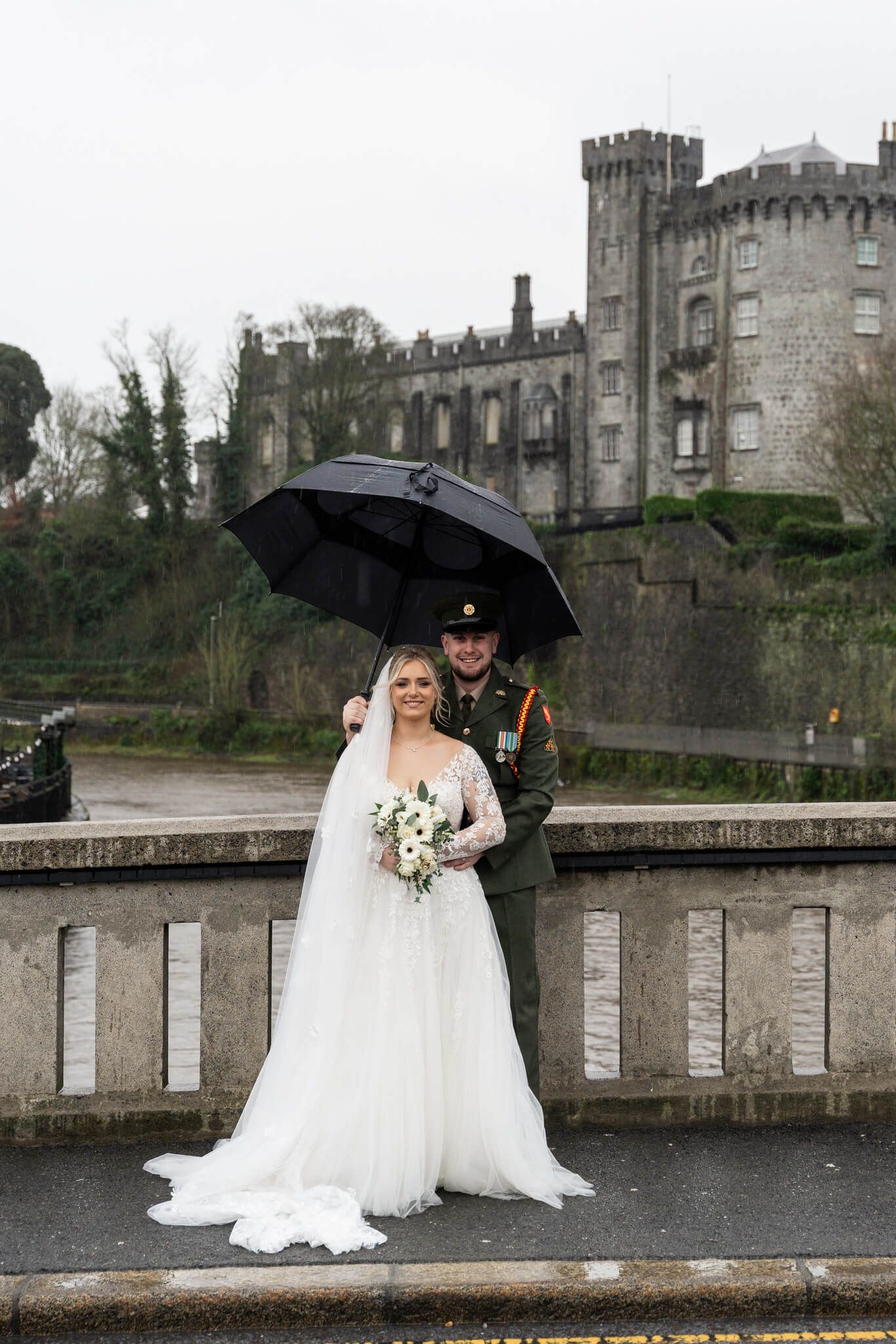 Bride and groom portrait on bridge in front of Kilkenny castle photo by AK wedding photography and videography.