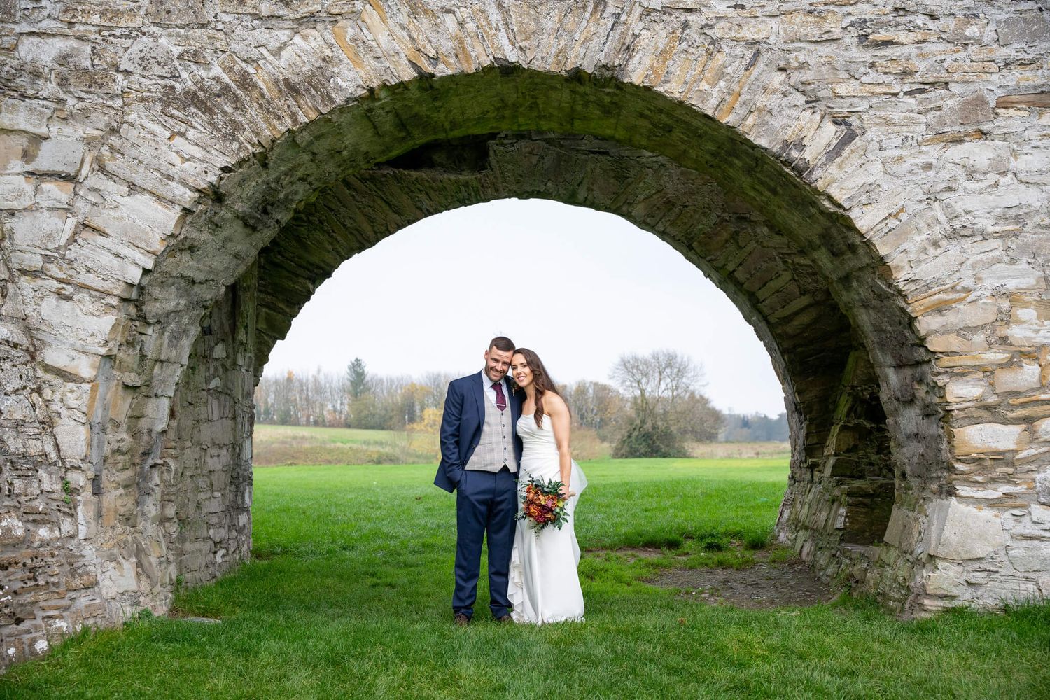 Bride and groom pose together at Trim Castle hotel, Trim, County Meath photo by AK wedding photography and videography.