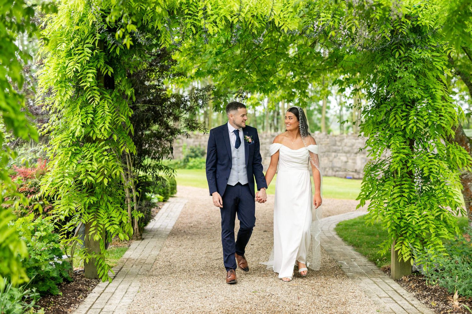 Bride in a white off-shoulder gown and groom in a at Johnstown house, Kildare photo by AK wedding photography and videography.