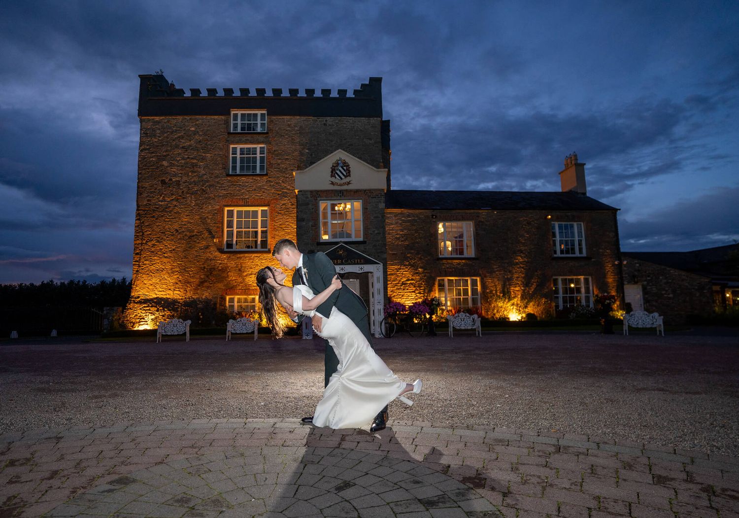 Dramatic night wedding portrait in front of Darver Castle, County Louth. Photo by AK wedding photography and videography.