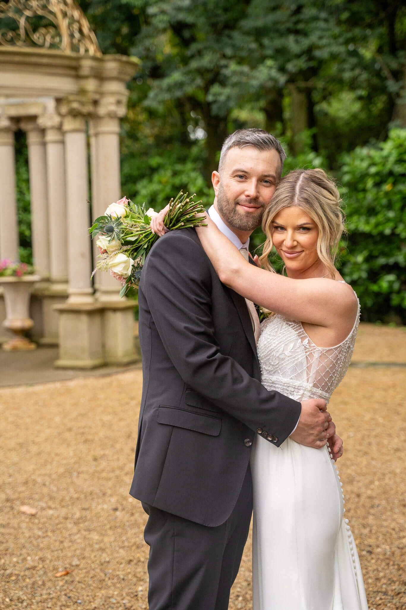 Smiling bride and groom embracing at Kilashee house, Naas, Cuunty Kildare photo by AK wedding photography and videography.