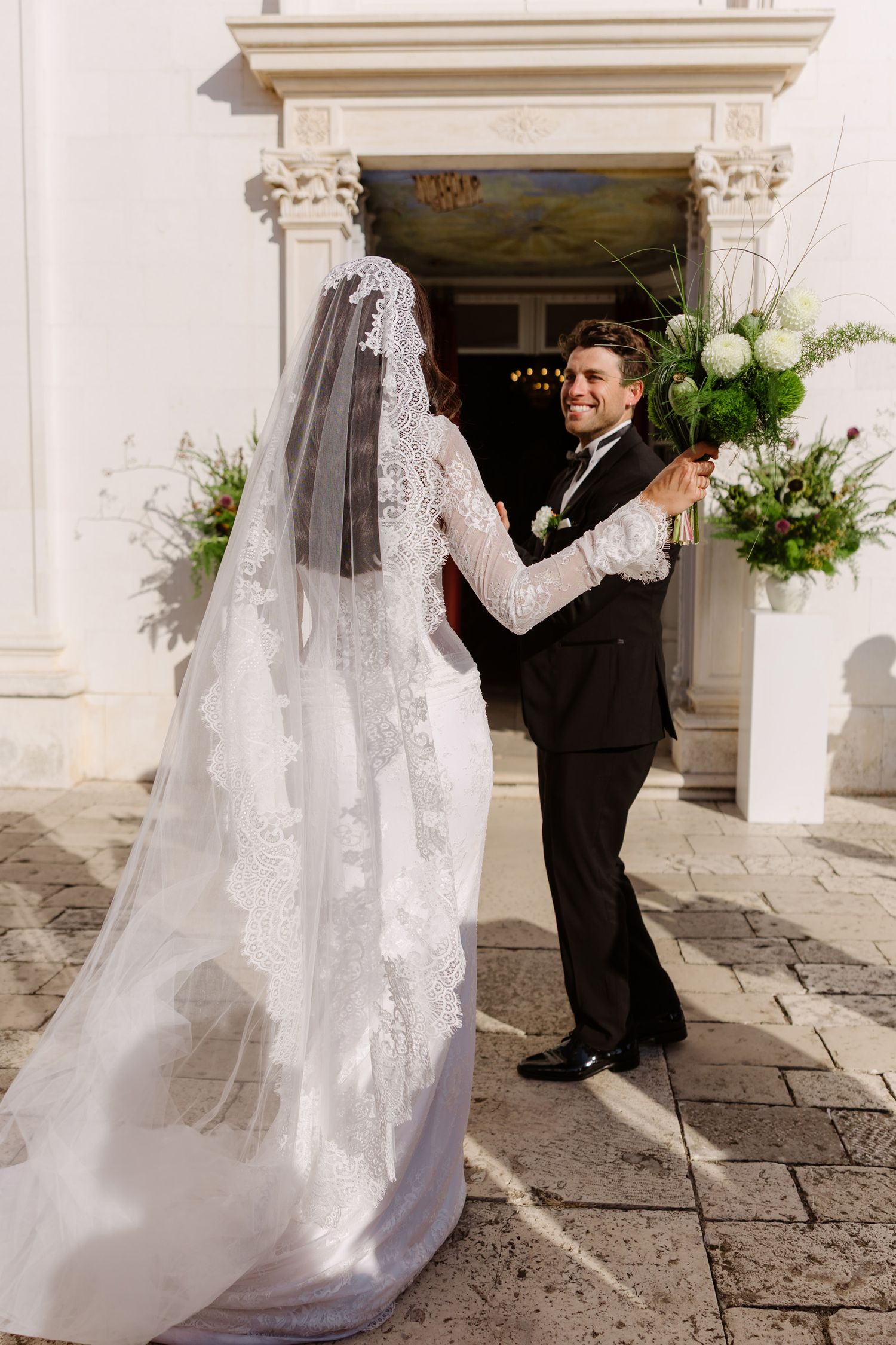 Elegant wedding couple poses in sequence against classic white stone building entrance.