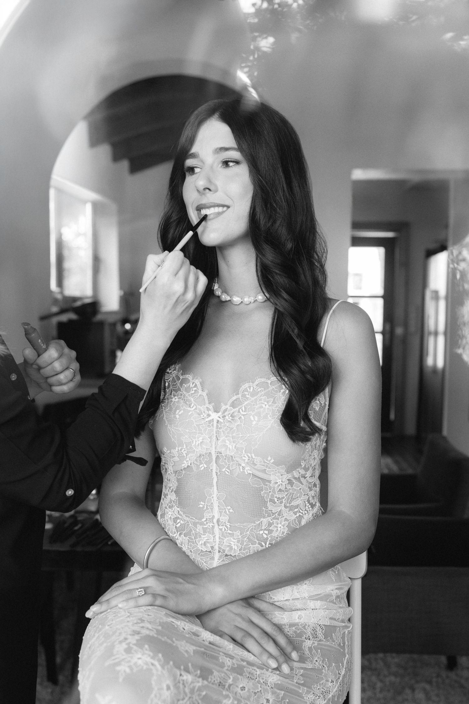 Black and white portrait series showing elegant bridal makeup and hair preparation.