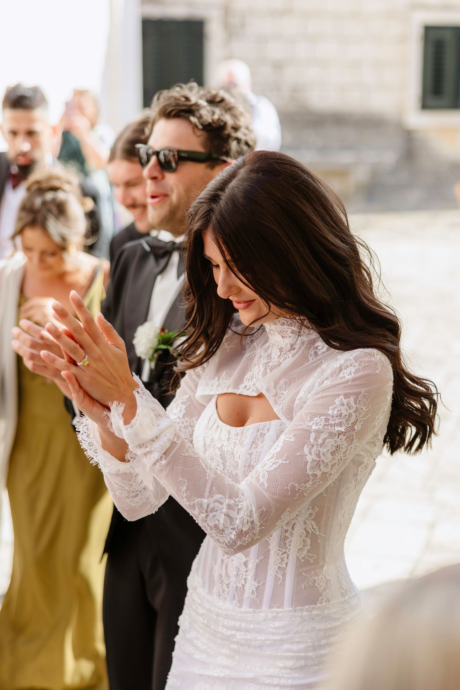 Joyful celebration moment at a wedding with guests clapping and cheering.