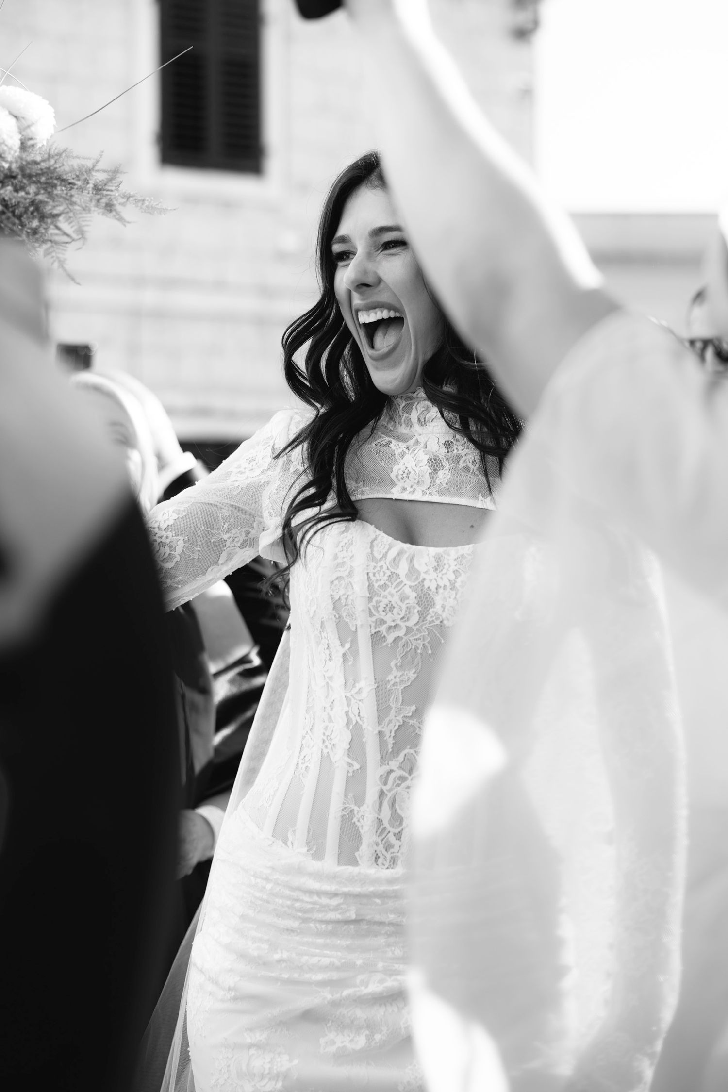 Black and white candid shots capturing joyful moments during wedding celebration.