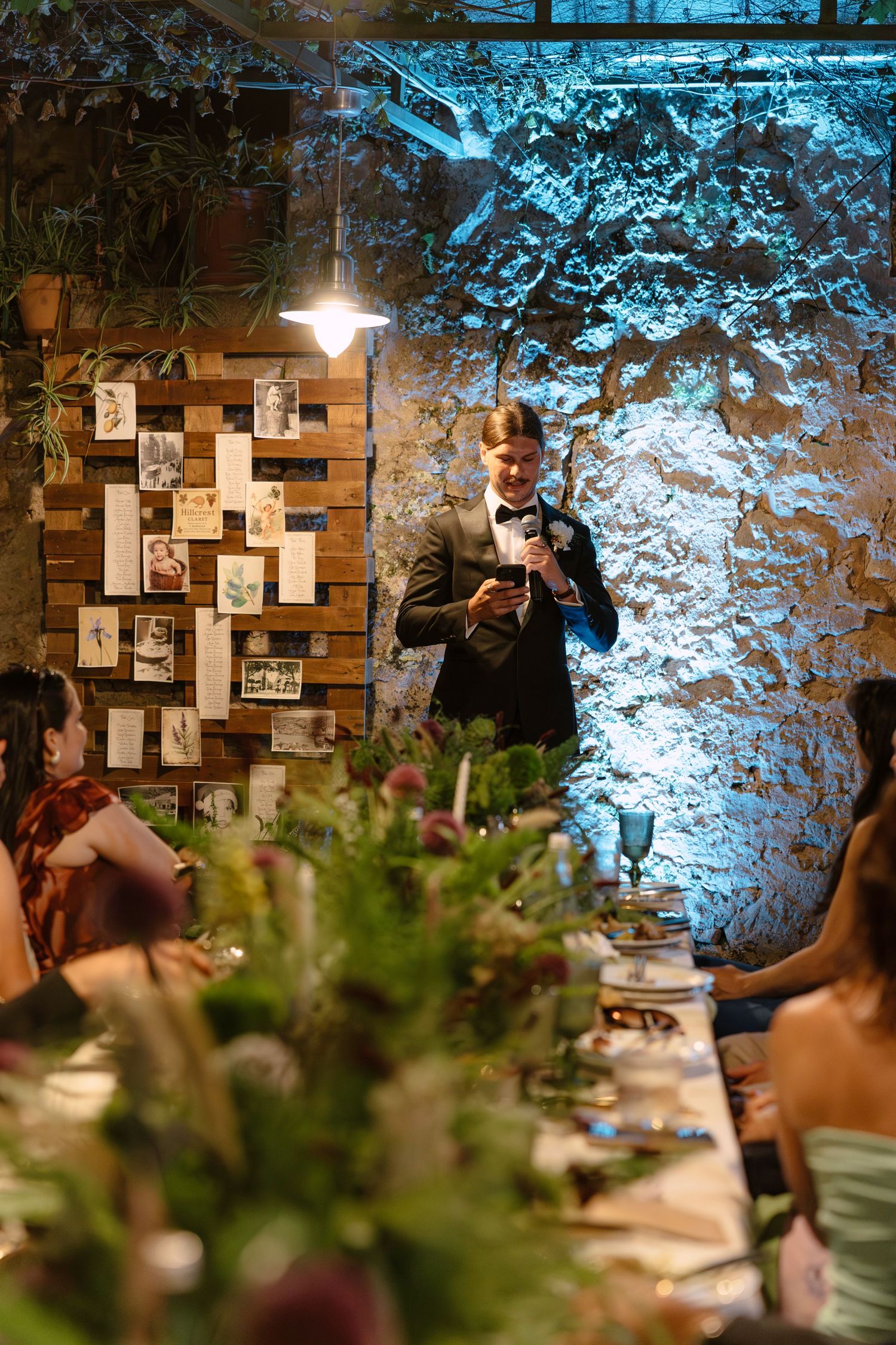 Reception venue with rustic wooden wall decor illuminated by blue lighting. Hvar, Croatia