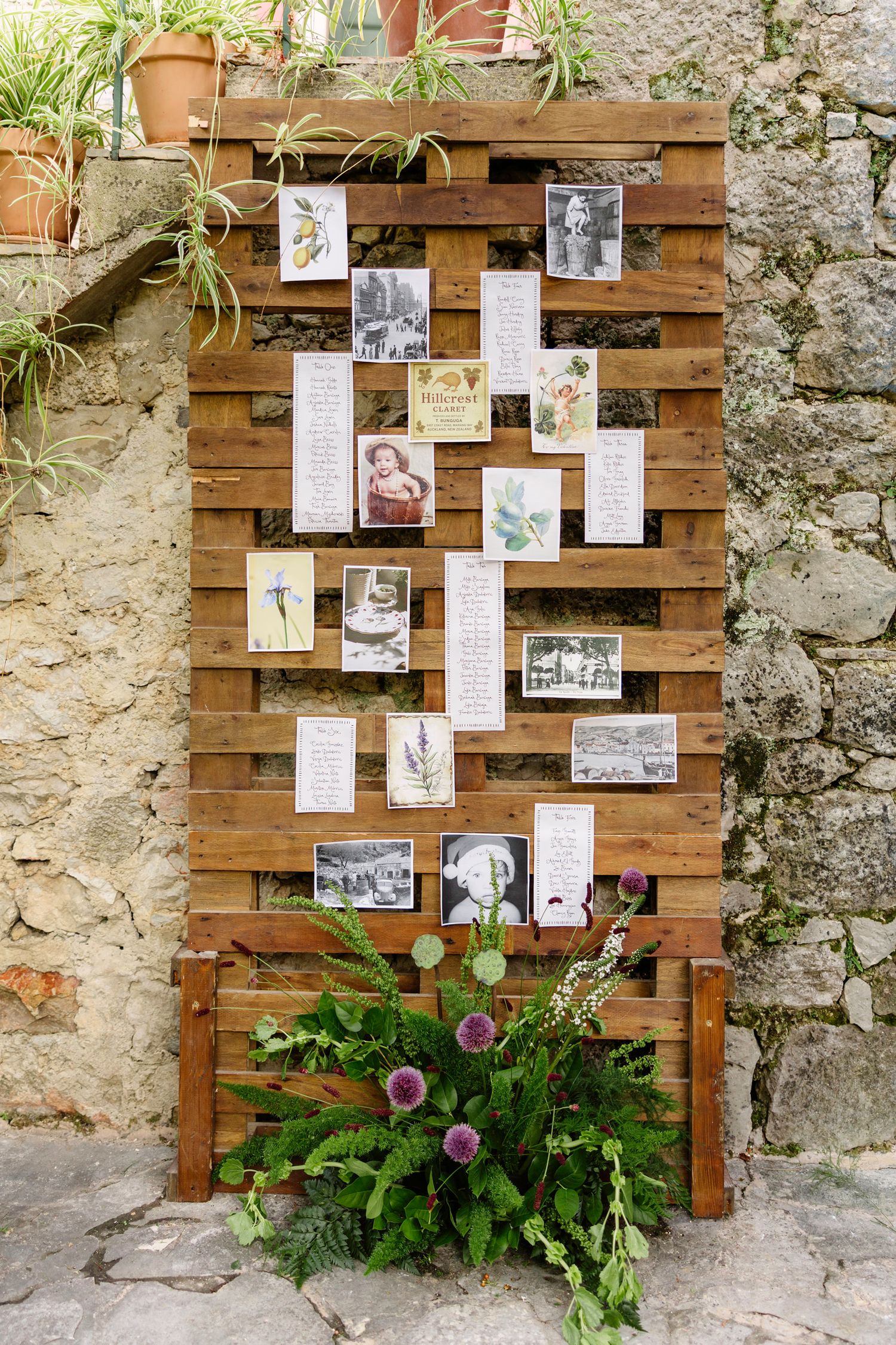 Rustic wooden wall display with vintage photographs and greenery creating a memory wall. Hvar, Croatia