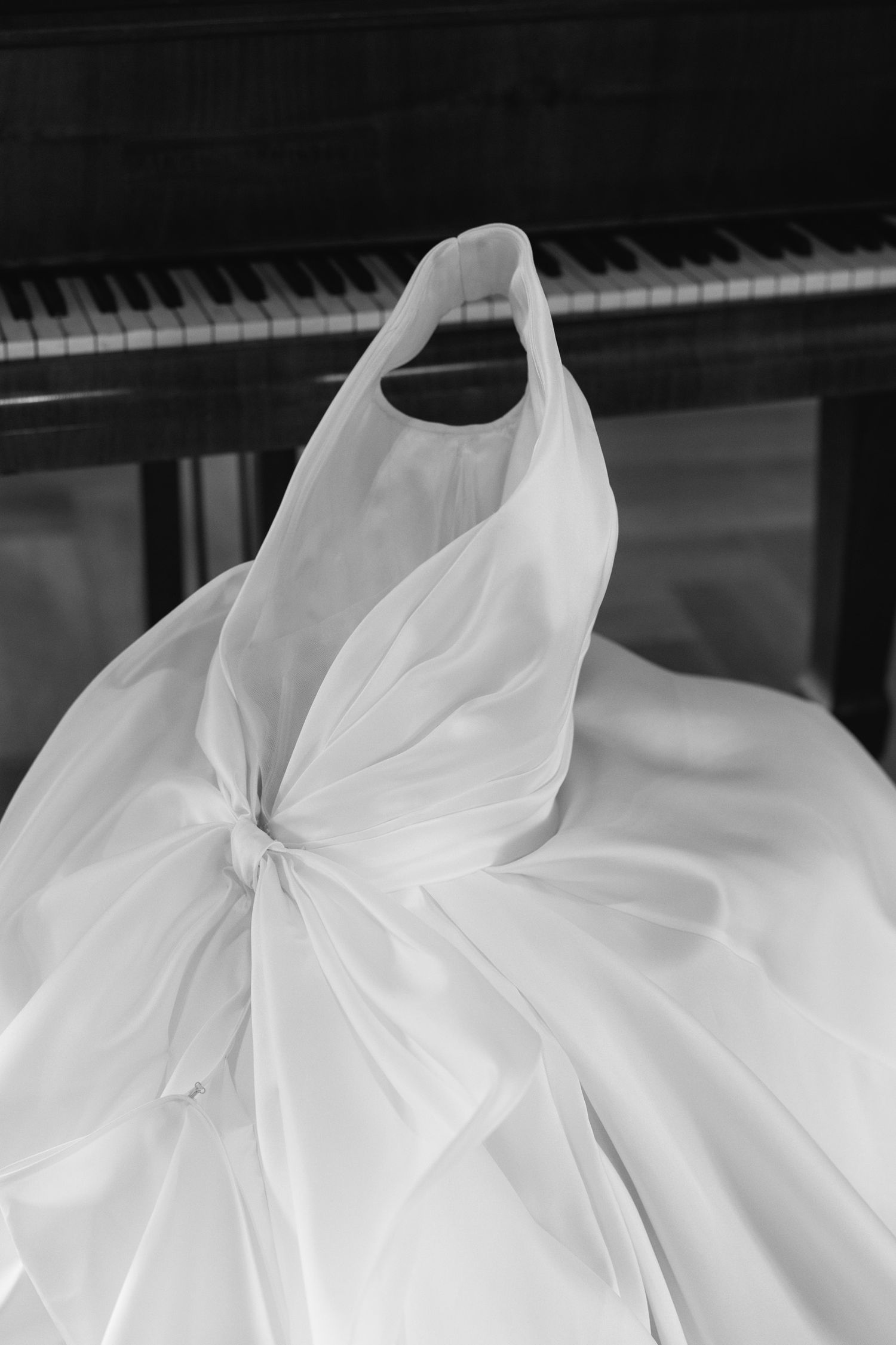 A series of black and white photographs showing the flowing folds and details of a white fabric or dress material.
