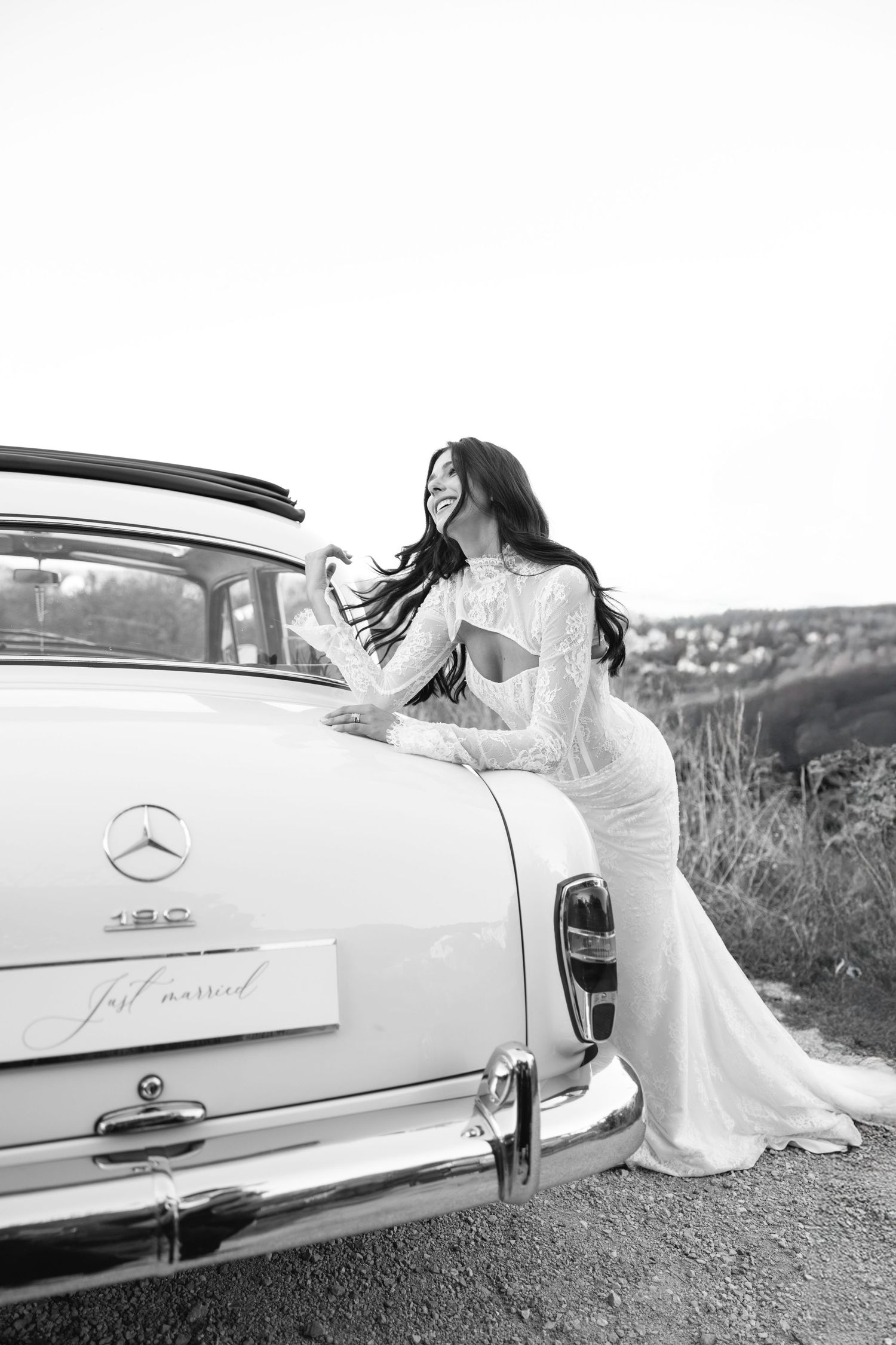 A series of black and white photos showing a bride in a flowing white dress posing elegantly next to a classic Mercedes-Benz car.
