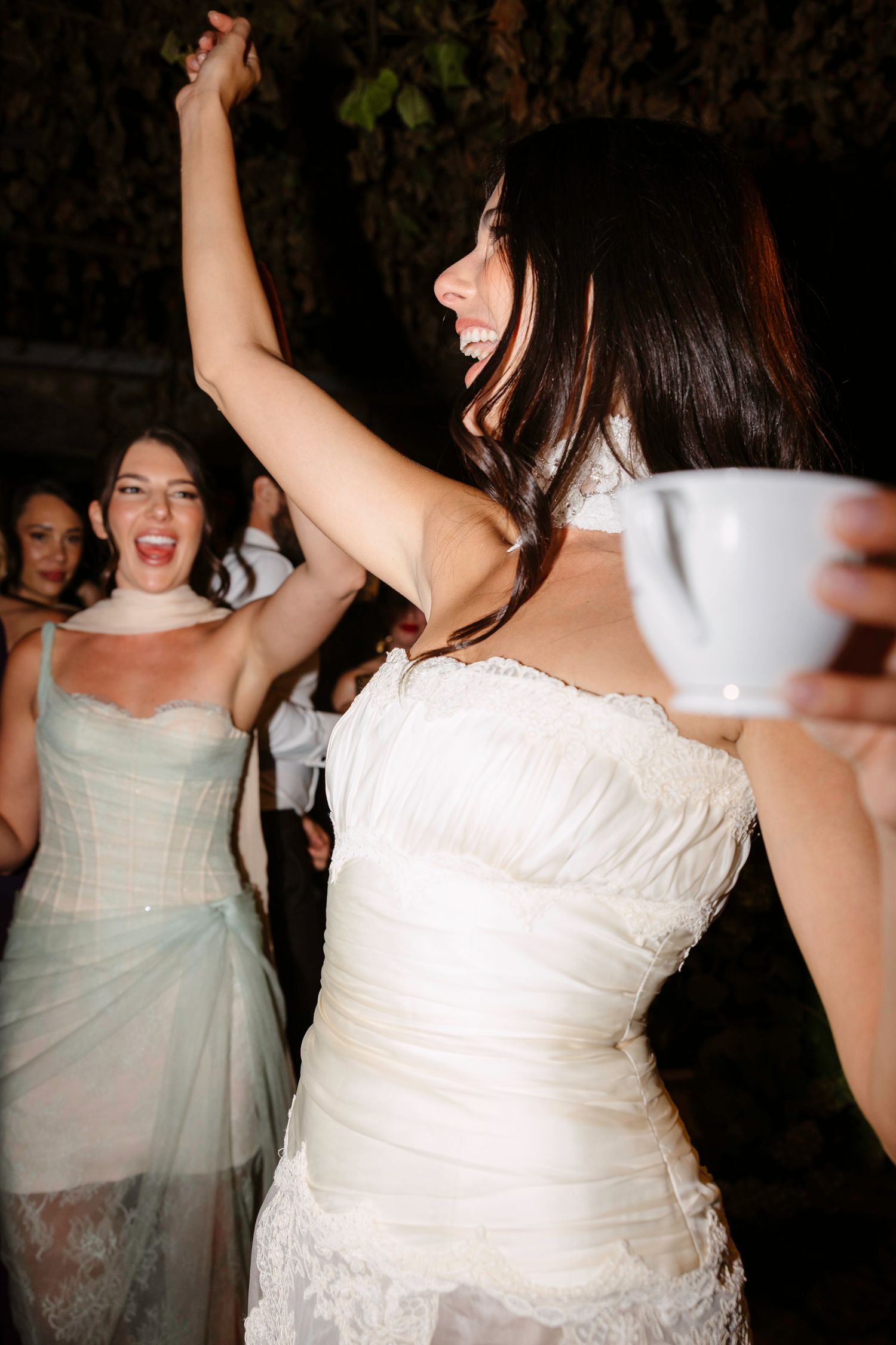 Wedding party guests dancing and celebrating at a reception with joyful energy. Hvar, Croatia