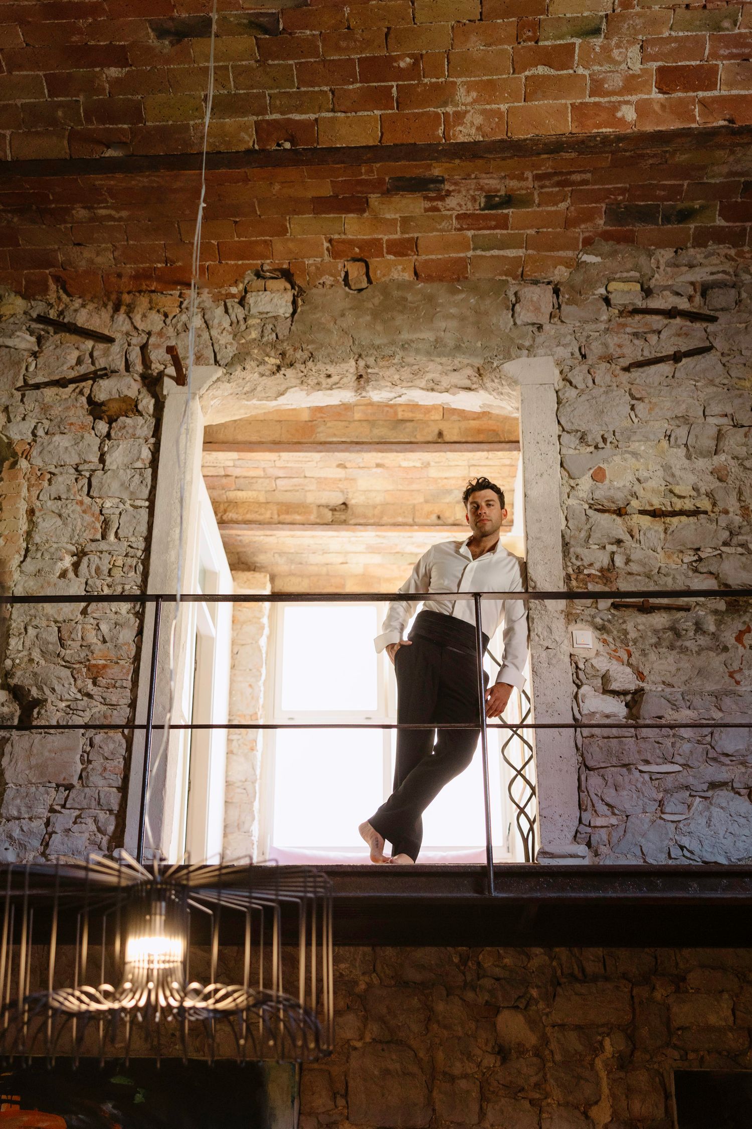 Artistic view through rustic brick archways in an old stone building interior.