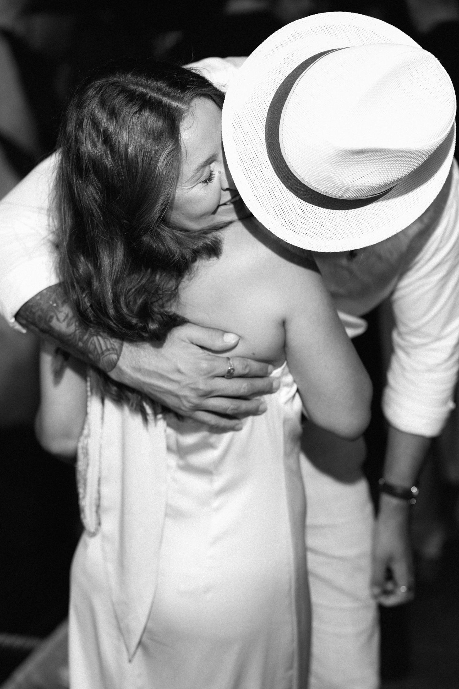 Black and white sequence showing intimate moments at a social gathering.