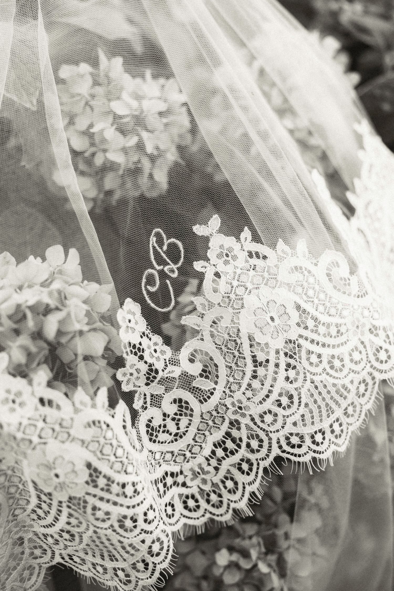 Delicate white lace trim with floral patterns and scalloped edges shown in close-up detail.