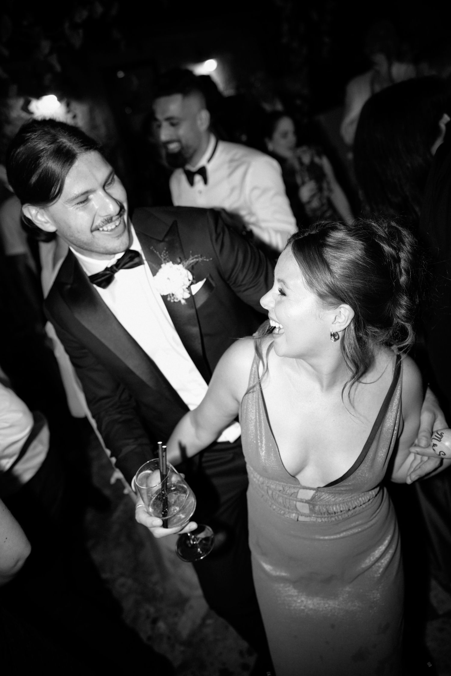 Wedding guests dancing and enjoying themselves at a dimly lit reception. Hvar, Croatia