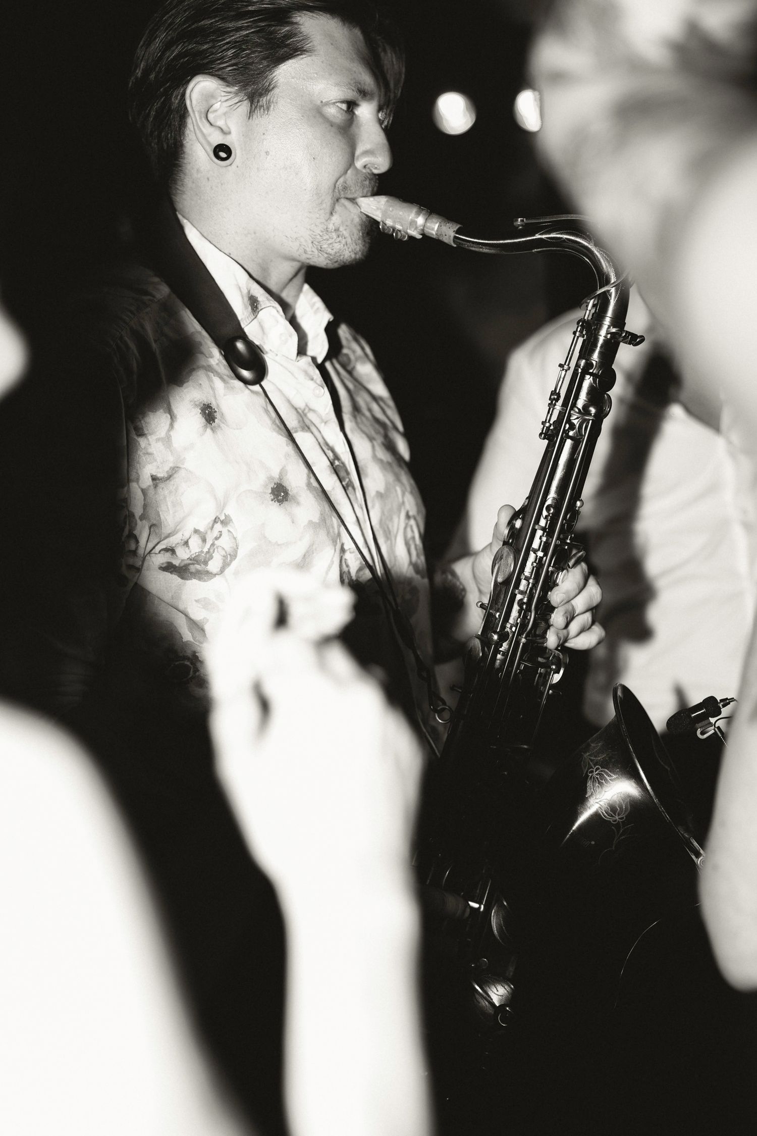 Black and white photo of someone playing a musical instrument at a wedding. Hvar, Croatia