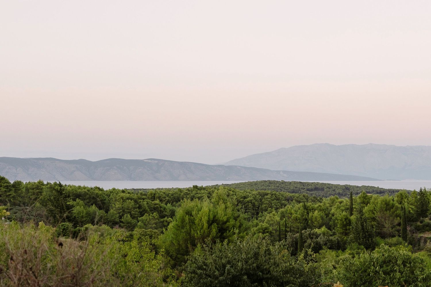 Panoramic mountain landscape view at sunset with rolling hills and forest. Hvar, Croatia