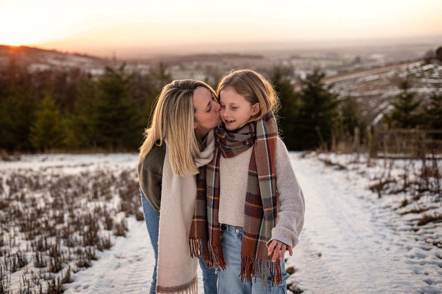 Mum and Daughter share a kiss during outdoor family photoshoot in Pocklington