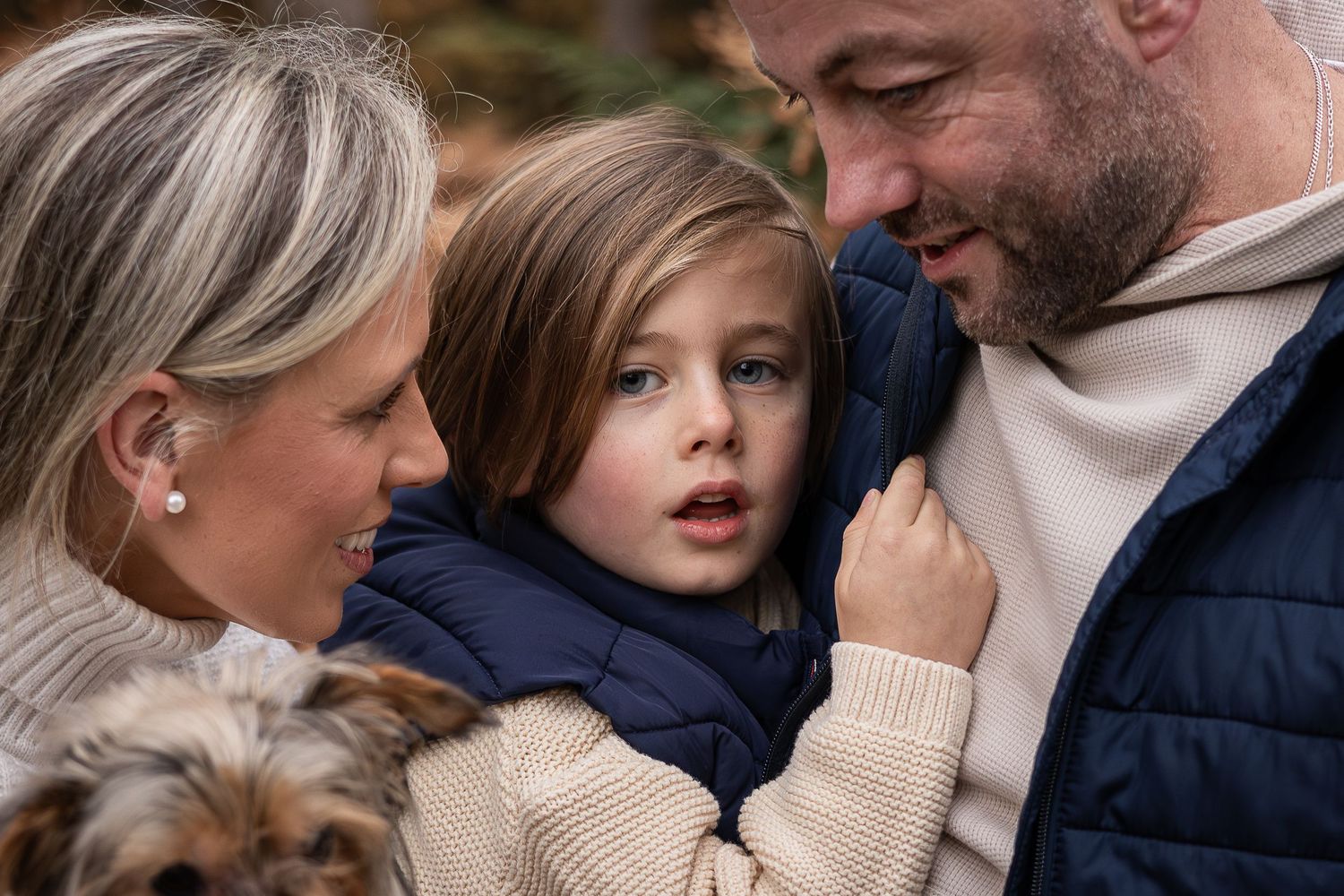 An intimate family portrait outdoors with warm autumn colors.