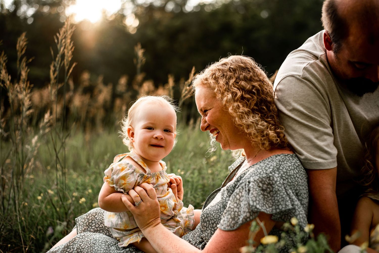 Joyful interaction in a sunlit meadow with tall grass and golden light.