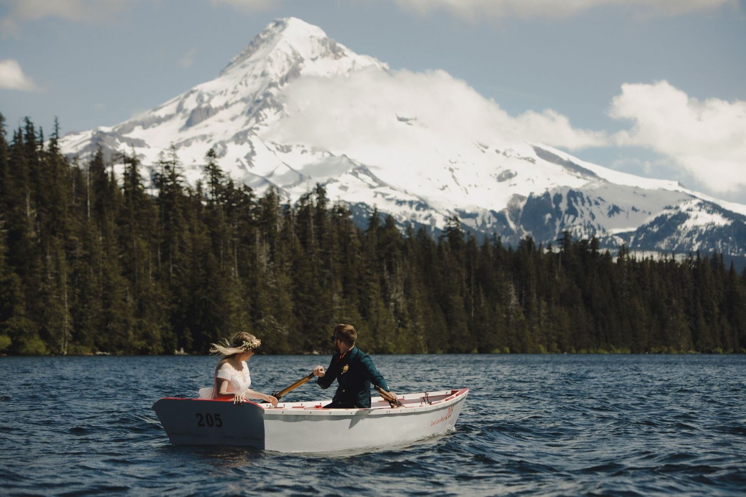 Small white boat with Mt Hood rising majestically in background on Lost Lake.