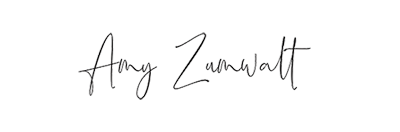 Elegant cursive signature of Amy Zumwalt in black ink on white background.
