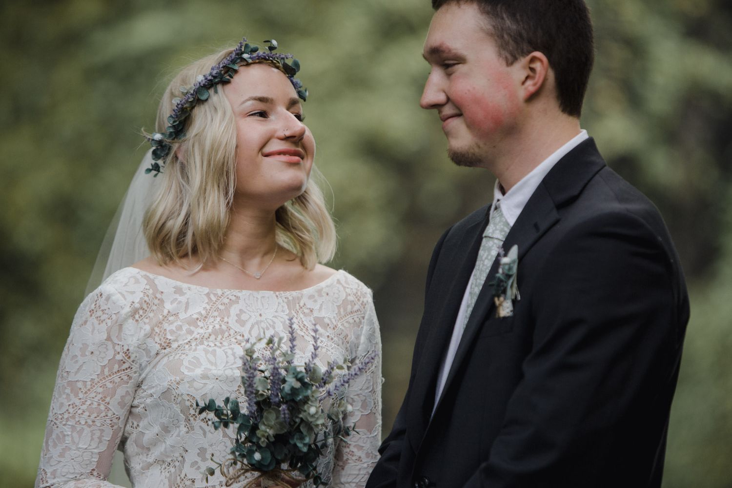 A couple shares a joyful moment during their outdoor wedding ceremony.