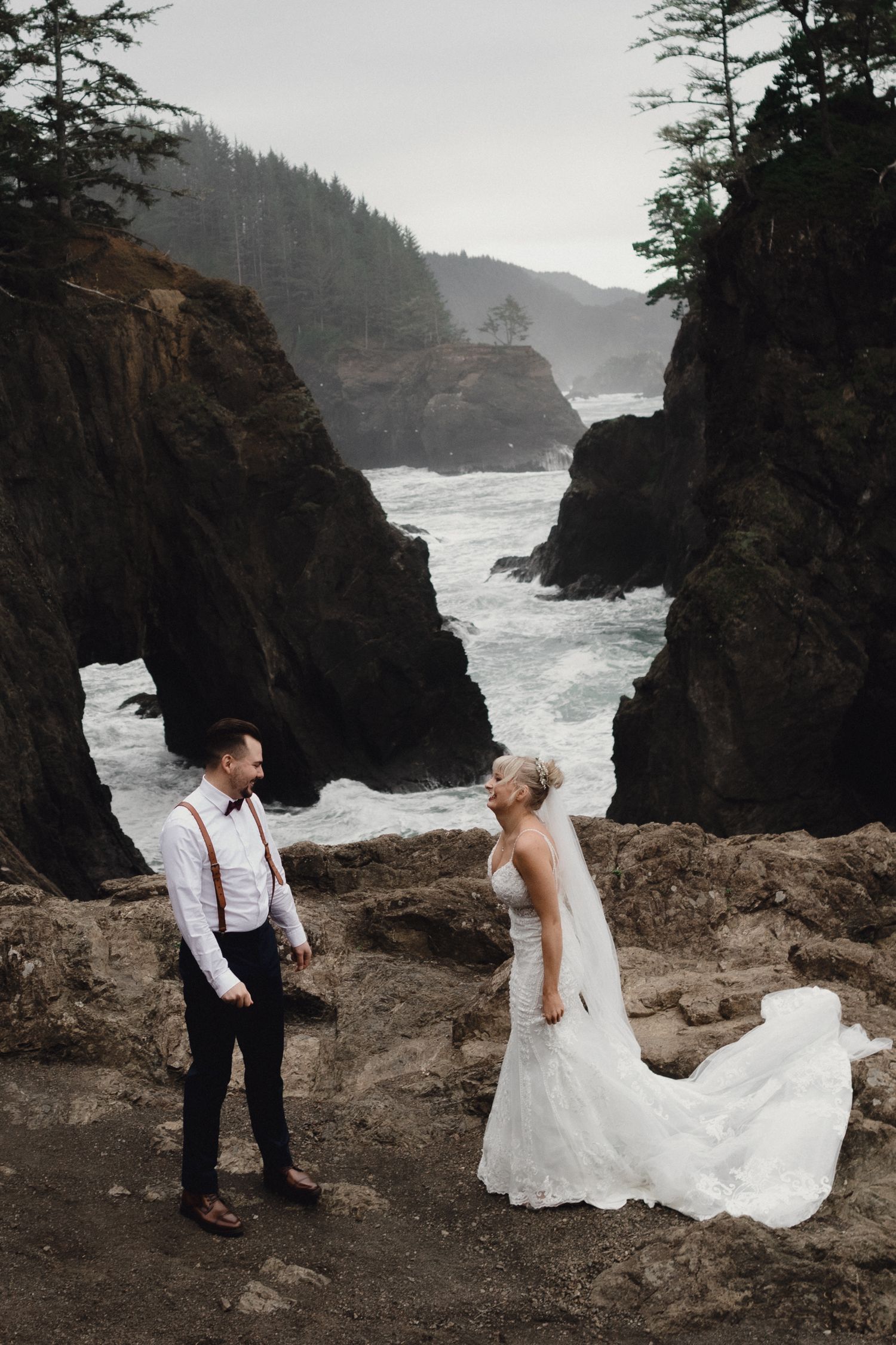 Intimate wedding moment captured against rugged Pacific Northwest coastline and cliffs.