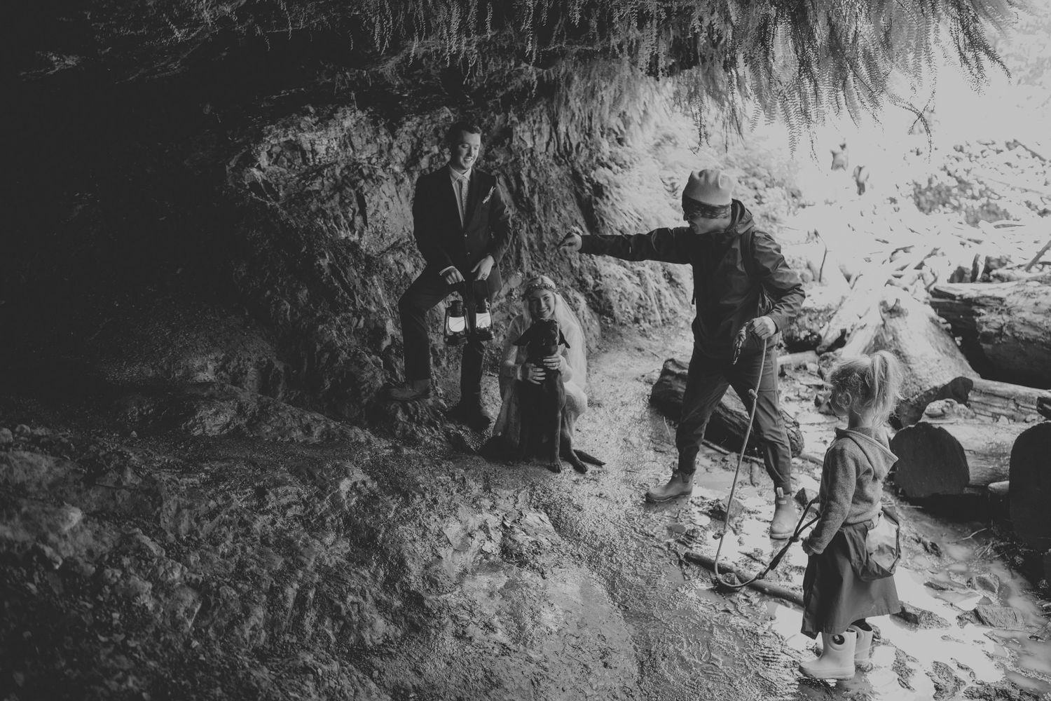 Vintage style photograph of people exploring a rocky cave formation.