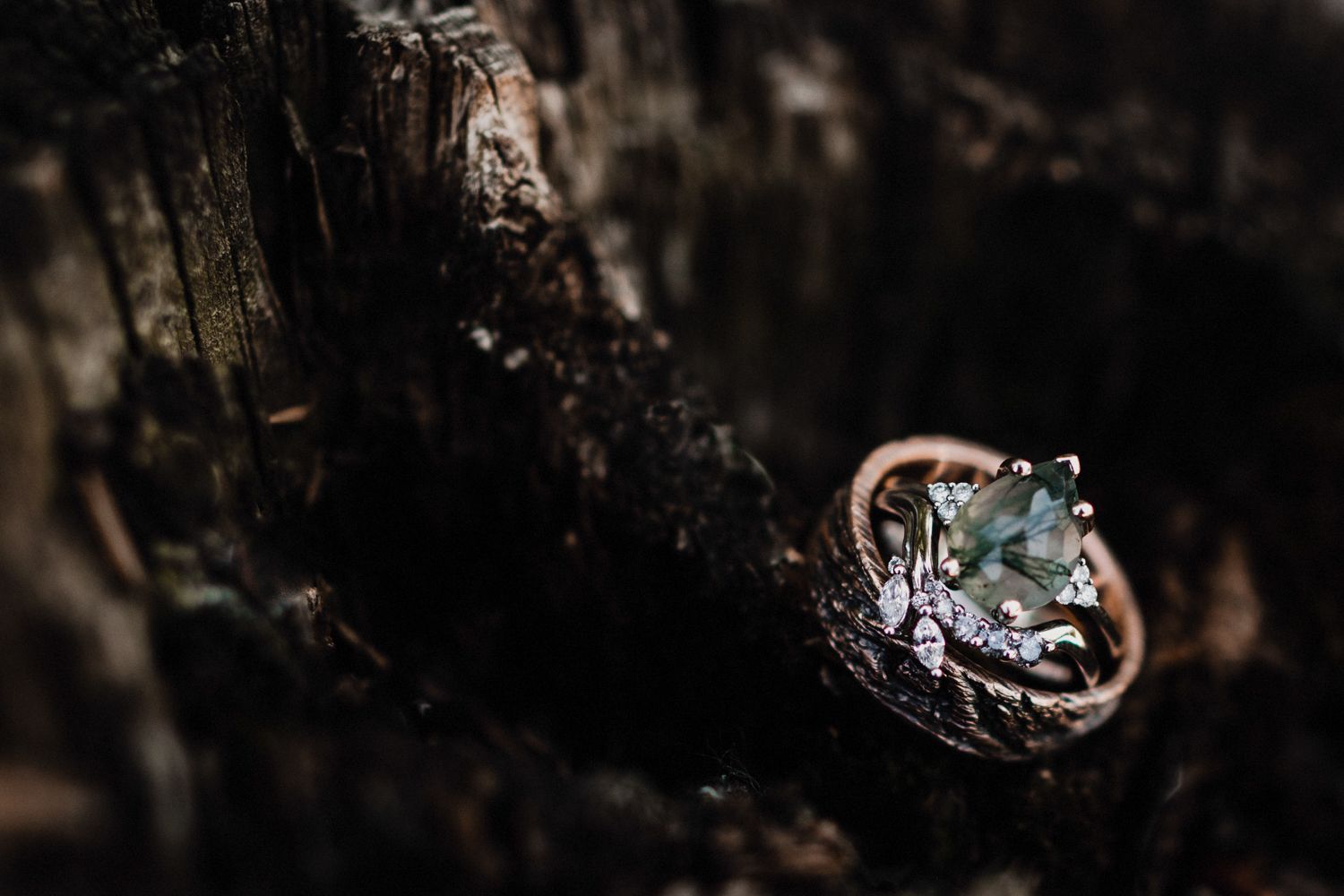 Close-up of a sparkling engagement ring with intricate details on wooden texture.