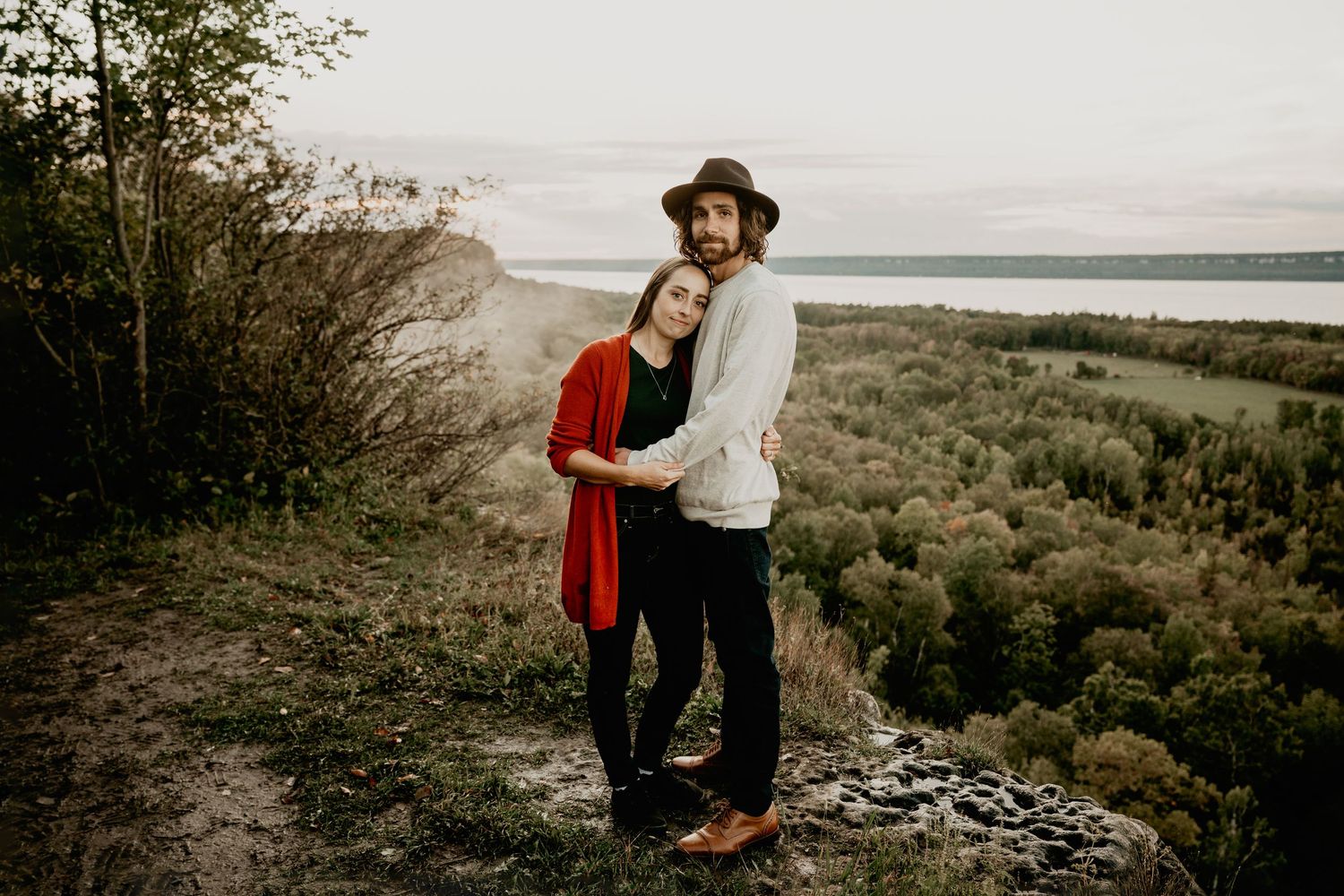 couple hugging on cliff top overlooking Georgian Bay