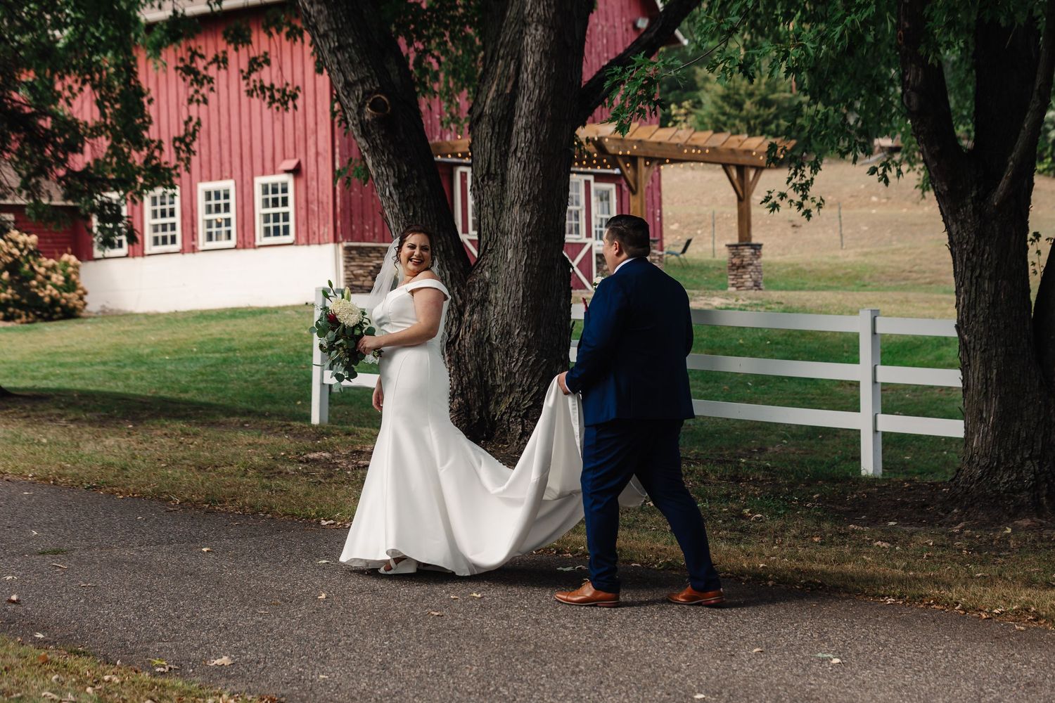 Groom holding brides dress