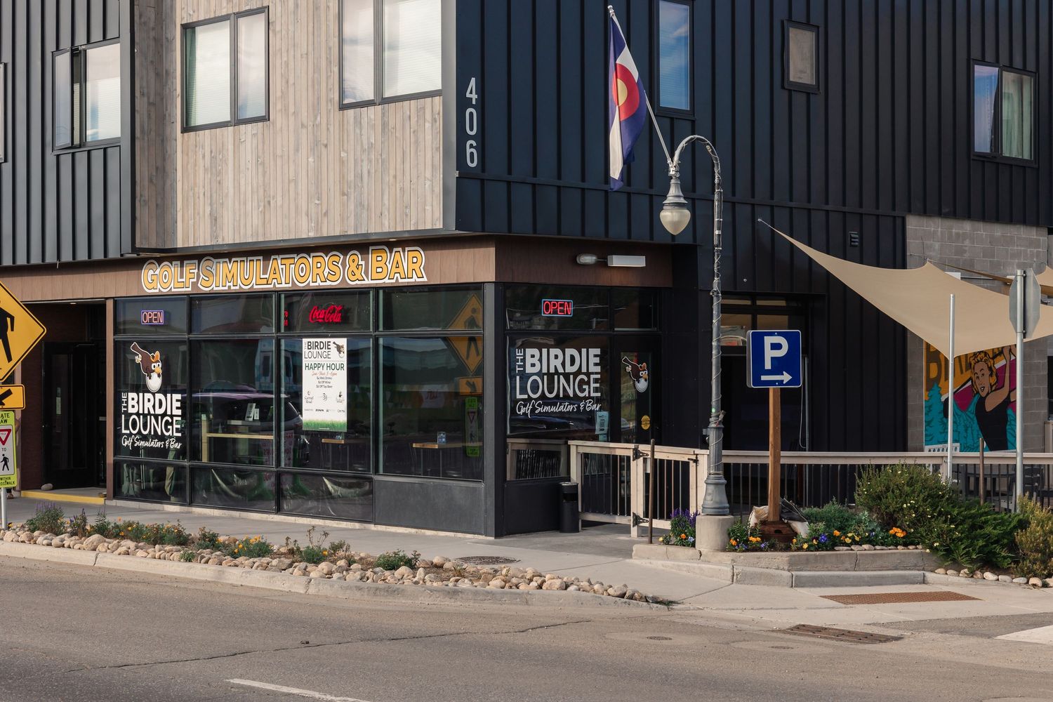 Modern corner building with dark exterior siding houses Rough Living retail store on street level.
