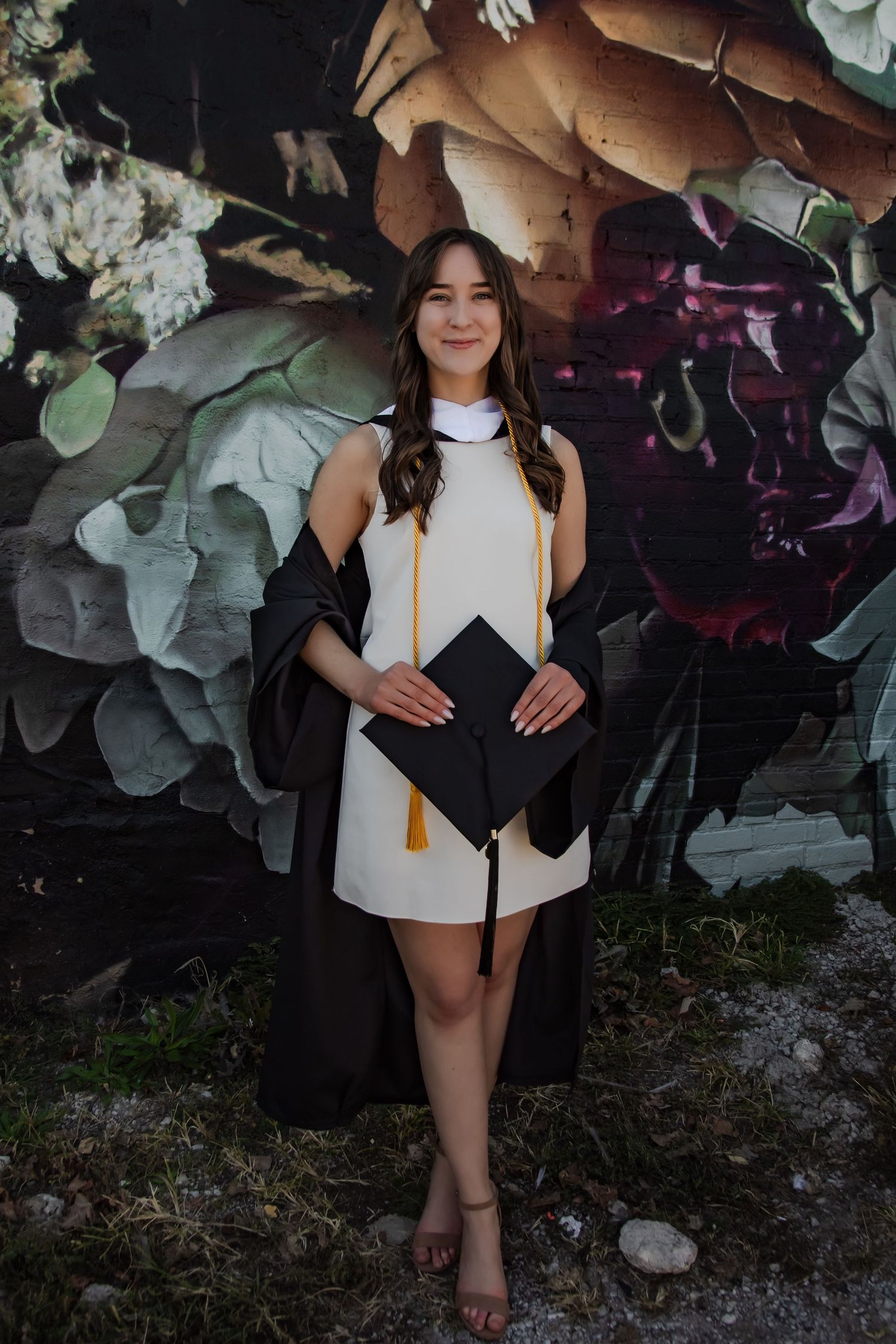 Graduation celebration photos with decorative background featuring academic regalia and gold tassel.