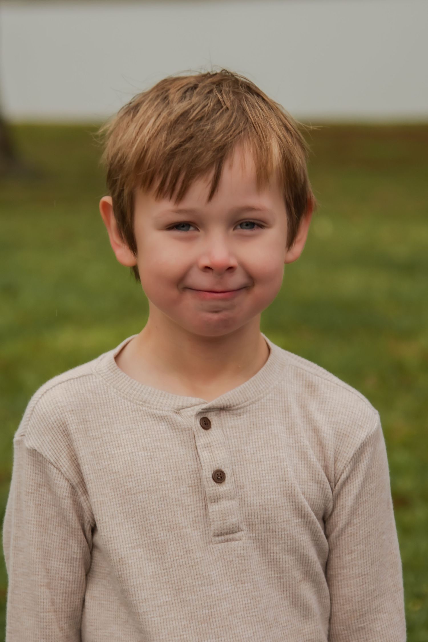 A sequence of expressive facial expressions captured in a series of outdoor portrait shots.