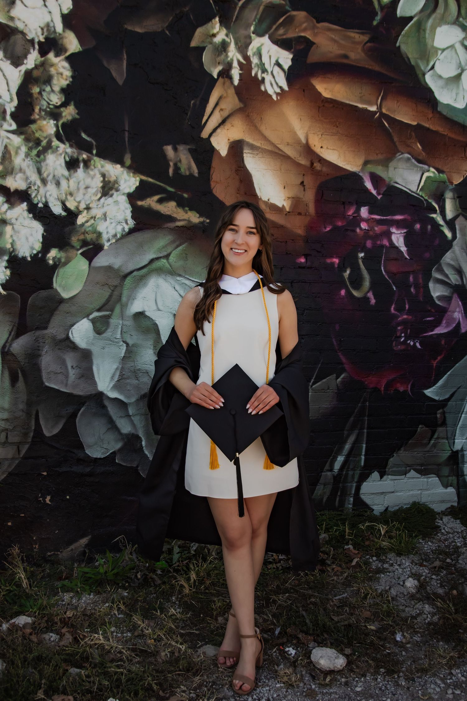Graduation photos against a floral backdrop with white and brown tones.