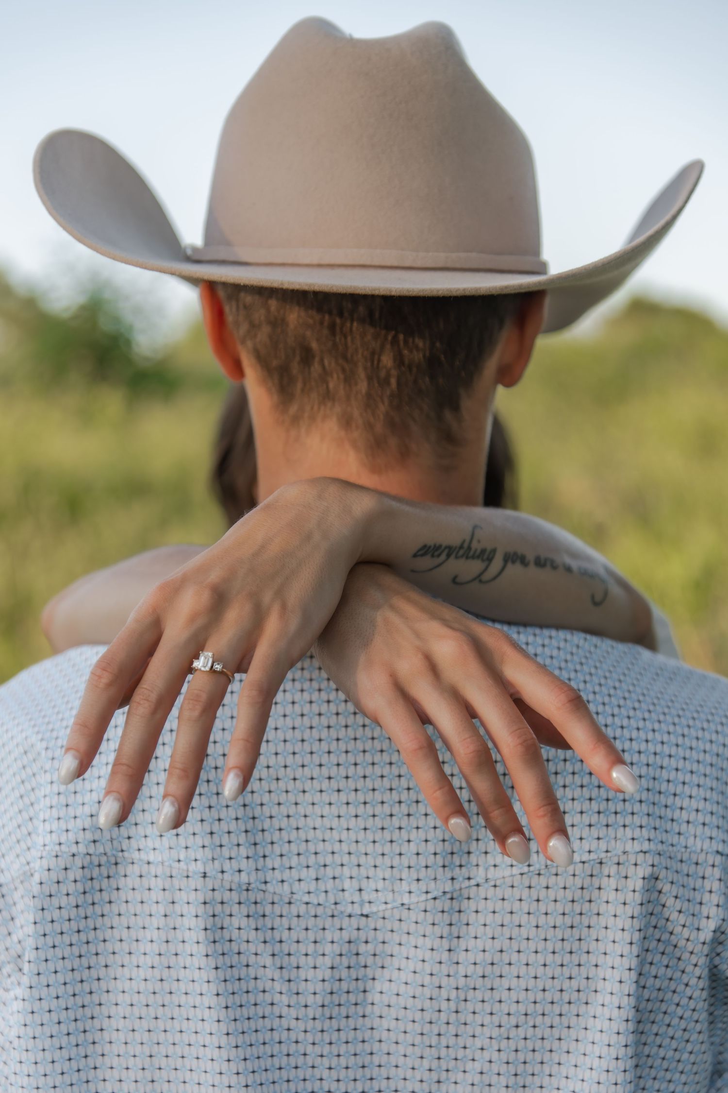 Series of hands against a light blue textured background with a beige cowboy hat partially visible in frame.