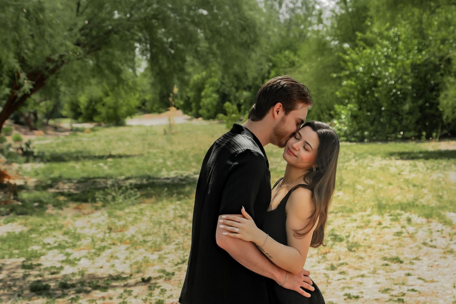 Couple sharing romantic moment in outdoor garden setting.