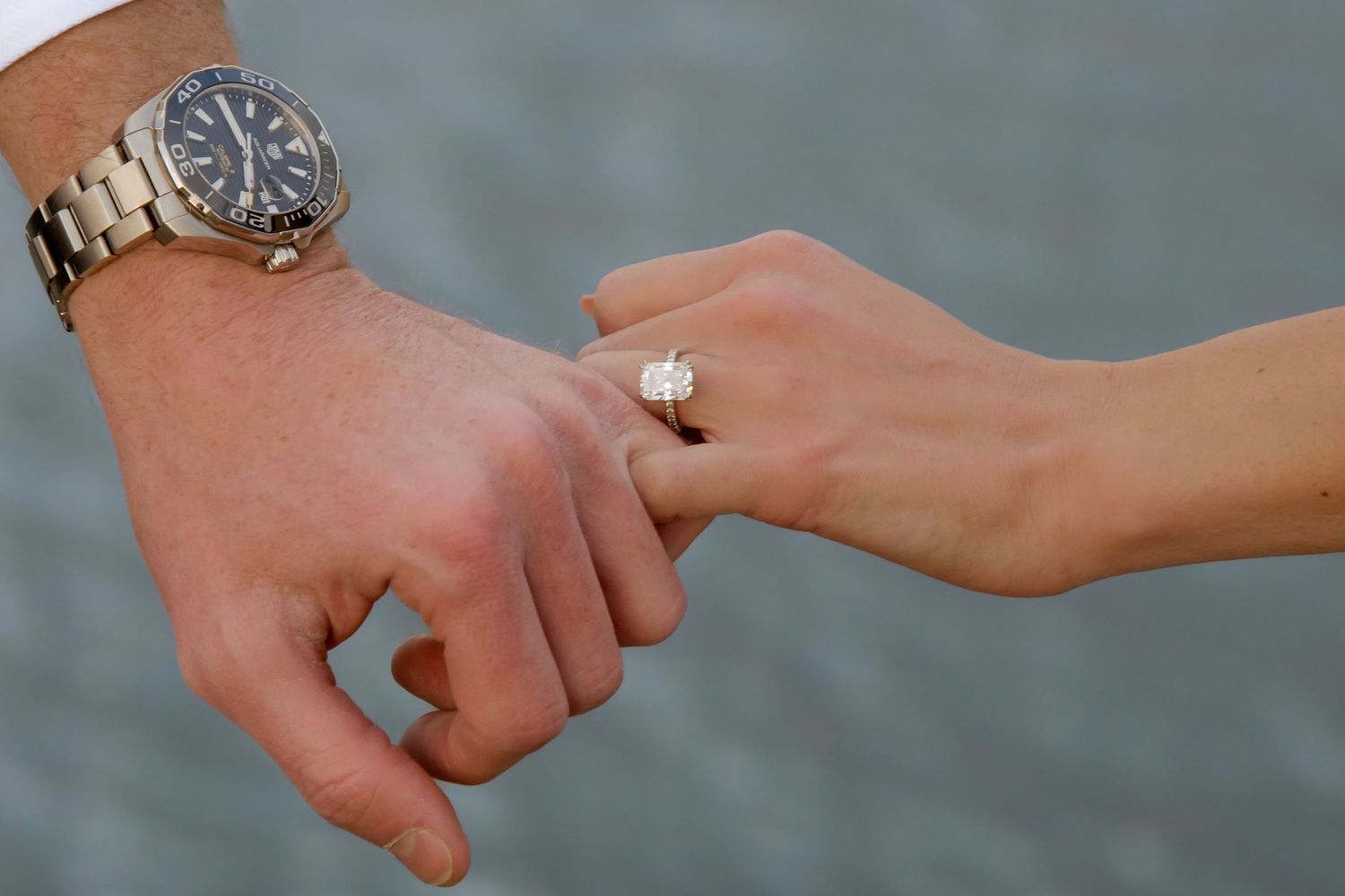Close-up of hands showing engagement rings in a row.