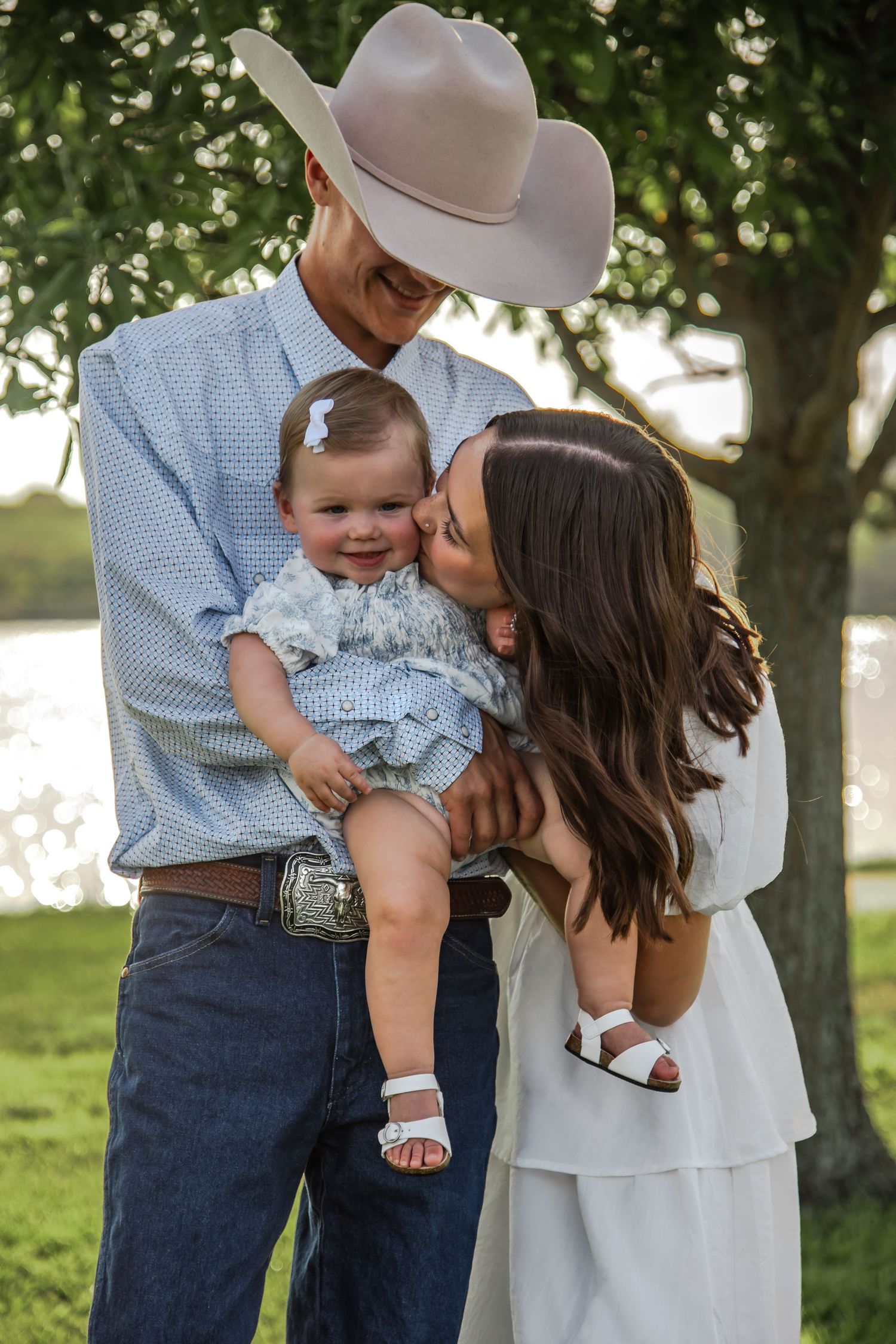 Sweet family moment captured in a series of candid outdoor photos showing parents kissing their young child in a grassy setting.