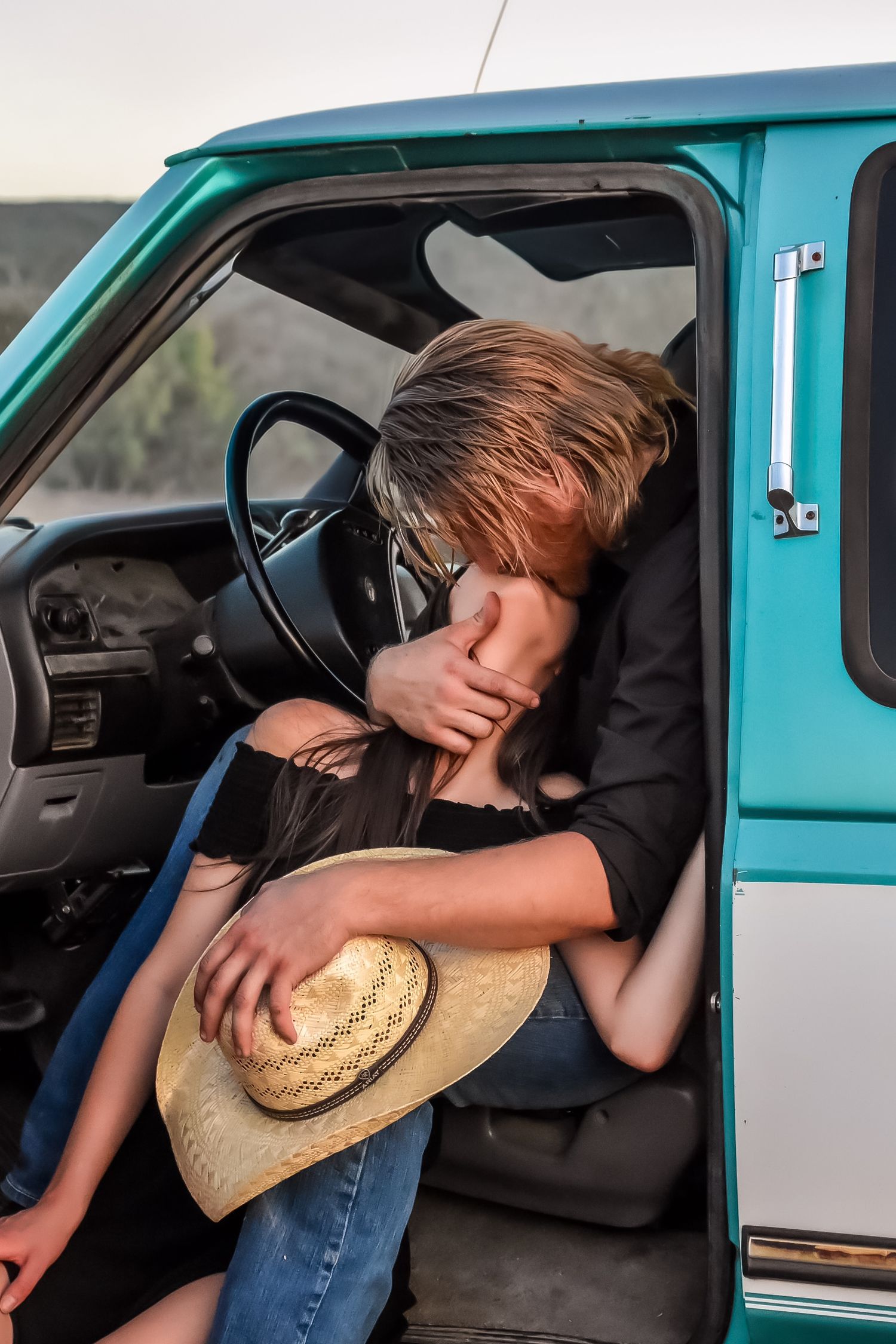 A sequence of photos showing someone sleeping in a turquoise car while wearing a straw hat.