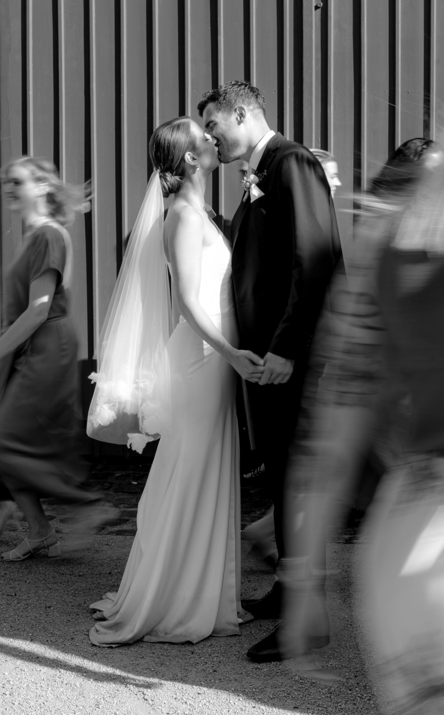 Black and white artistic wedding photo with motion blur creating dreamy atmosphere.